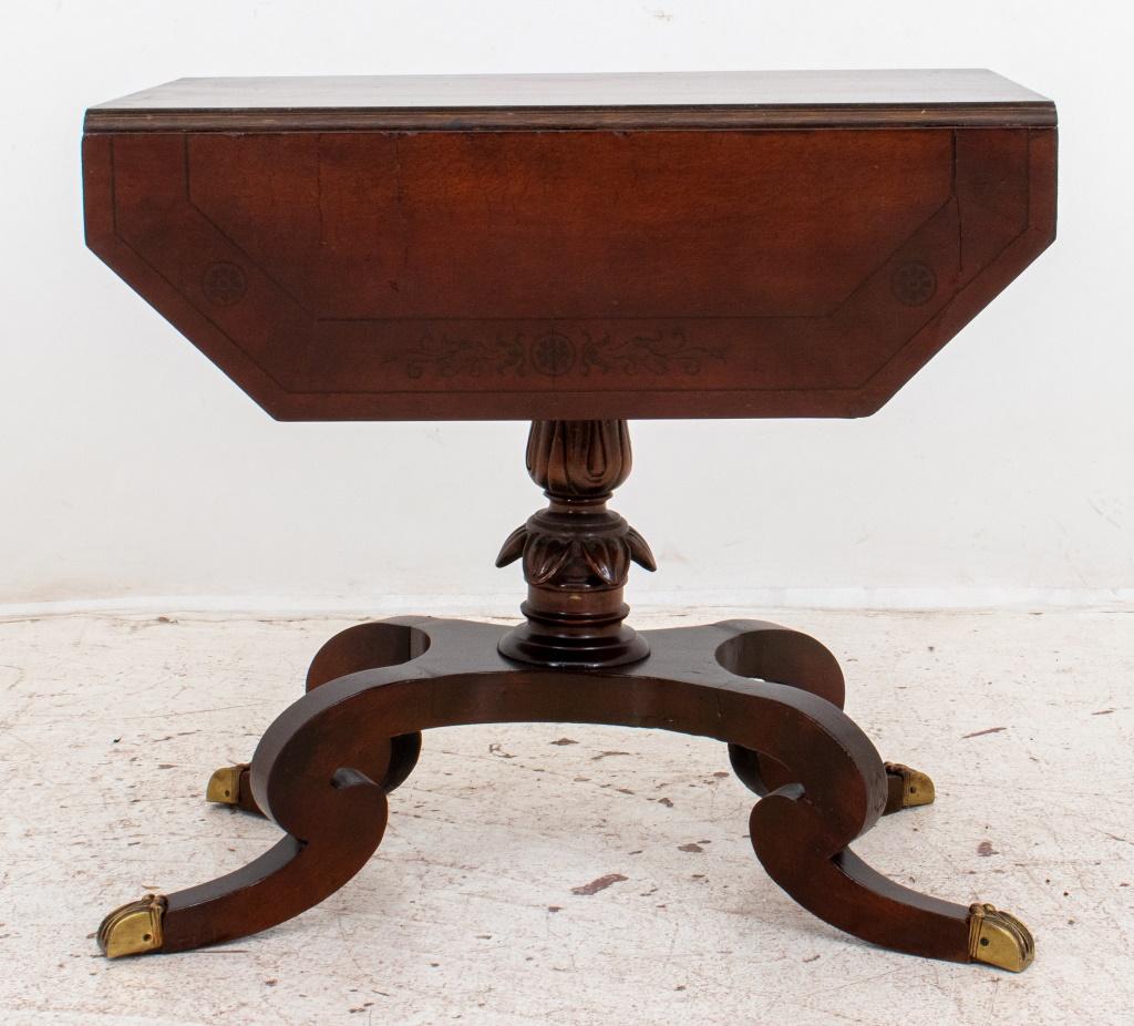 Regency Style mahogany drop-leaf sofa table having one drawer, raised on acanthus craved pedestal ending with four curved, tapering legs with brass caps. In good vintage condition. Wear consistent with age and use.

Dimensions26.5