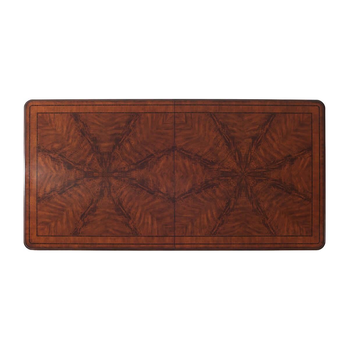 An English Regency style crossbanded flame veneered and solid mahogany twin pedestal extending dining table, the molded edge top with rounded corners above a plain frieze opening to accommodate an additional leaf, on baluster turned column supports