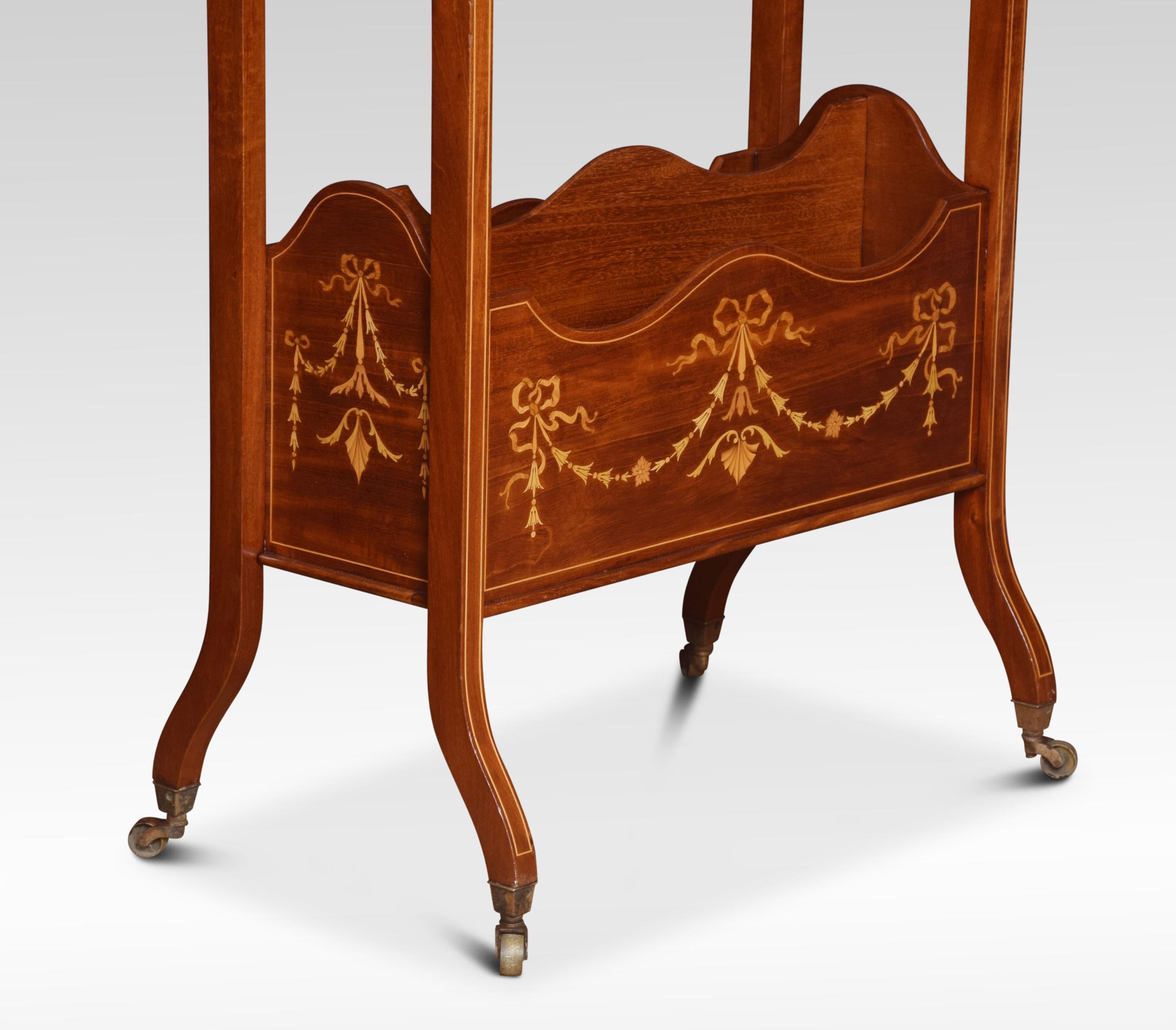 Regency style inlaid mahogany freestanding book trough, the trough above a single shelf and twin compartment magazine rack, inlaid with harebell swags and stringing. Raised up on slender out swept legs of square section terminating in brass