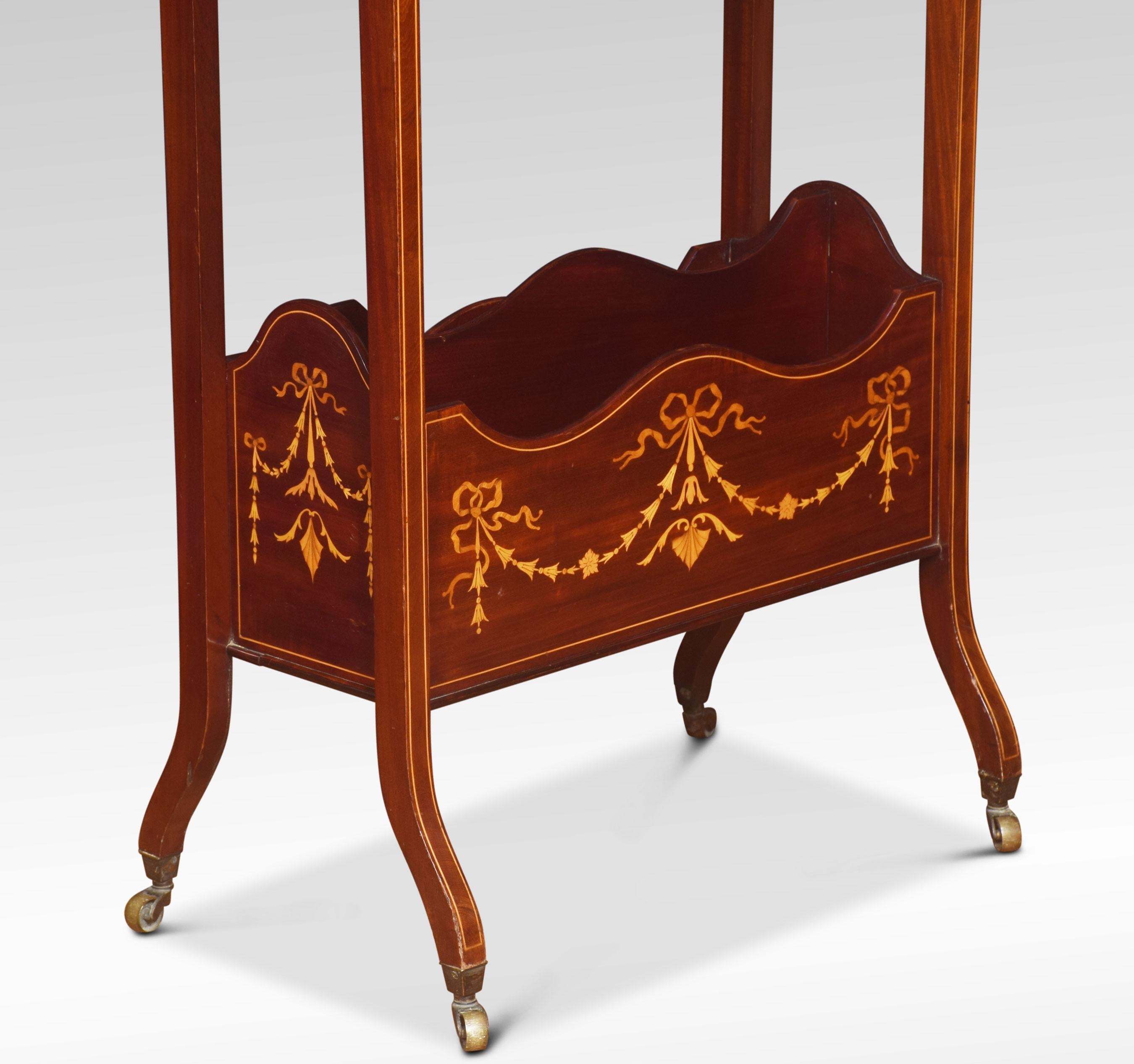 Regency style inlaid mahogany freestanding book trough, the trough above a single shelf and twin compartment magazine rack, inlaid with harebell swags and stringing. Raised up on slender out swept legs of square section terminating in brass