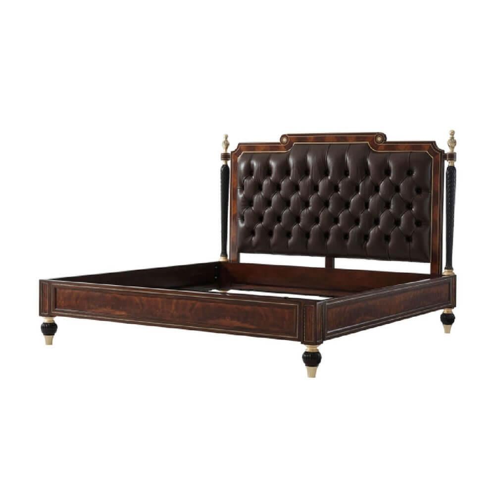 A fine Regency style flame mahogany and Morado banded bed with brass inlaid details, the arched headboard with brass inlaid rosettes flanked by brass finial columns in hand carved mahogany with gilt and ebonized details, the tufted upholstered