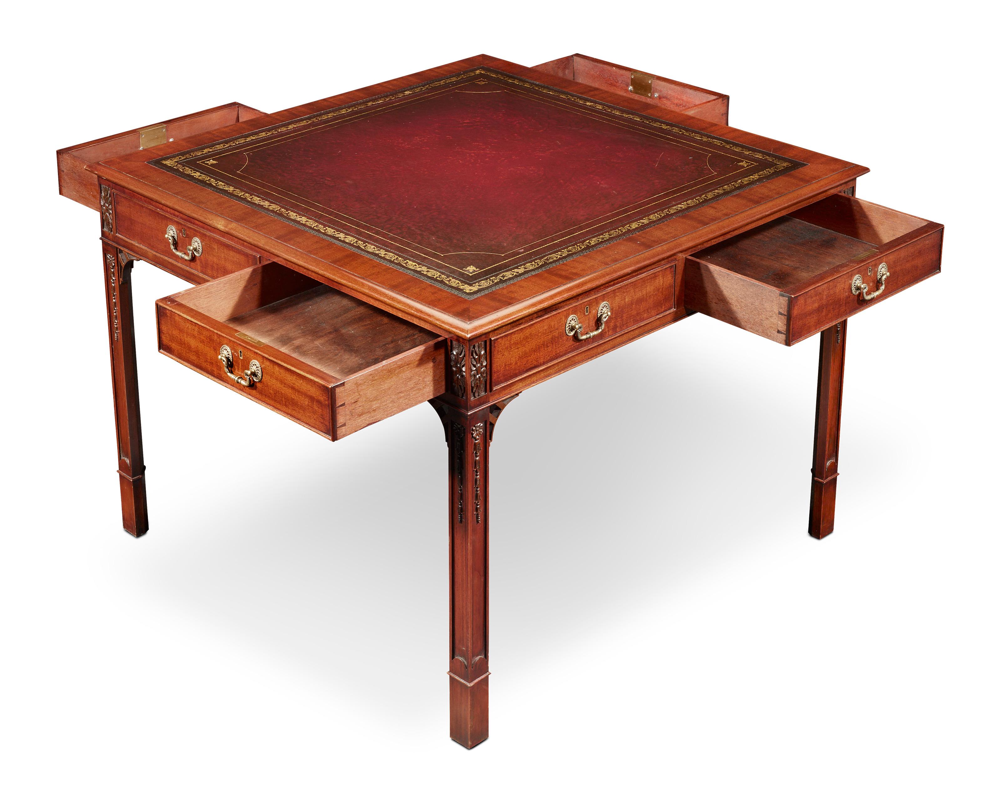 Crafted of rich mahogany, this library table displays all of the sophistication Regency-era furnishings are known for. This table features a straightforward design with beautifully carved details on the legs and frieze. A tooled and gilded red