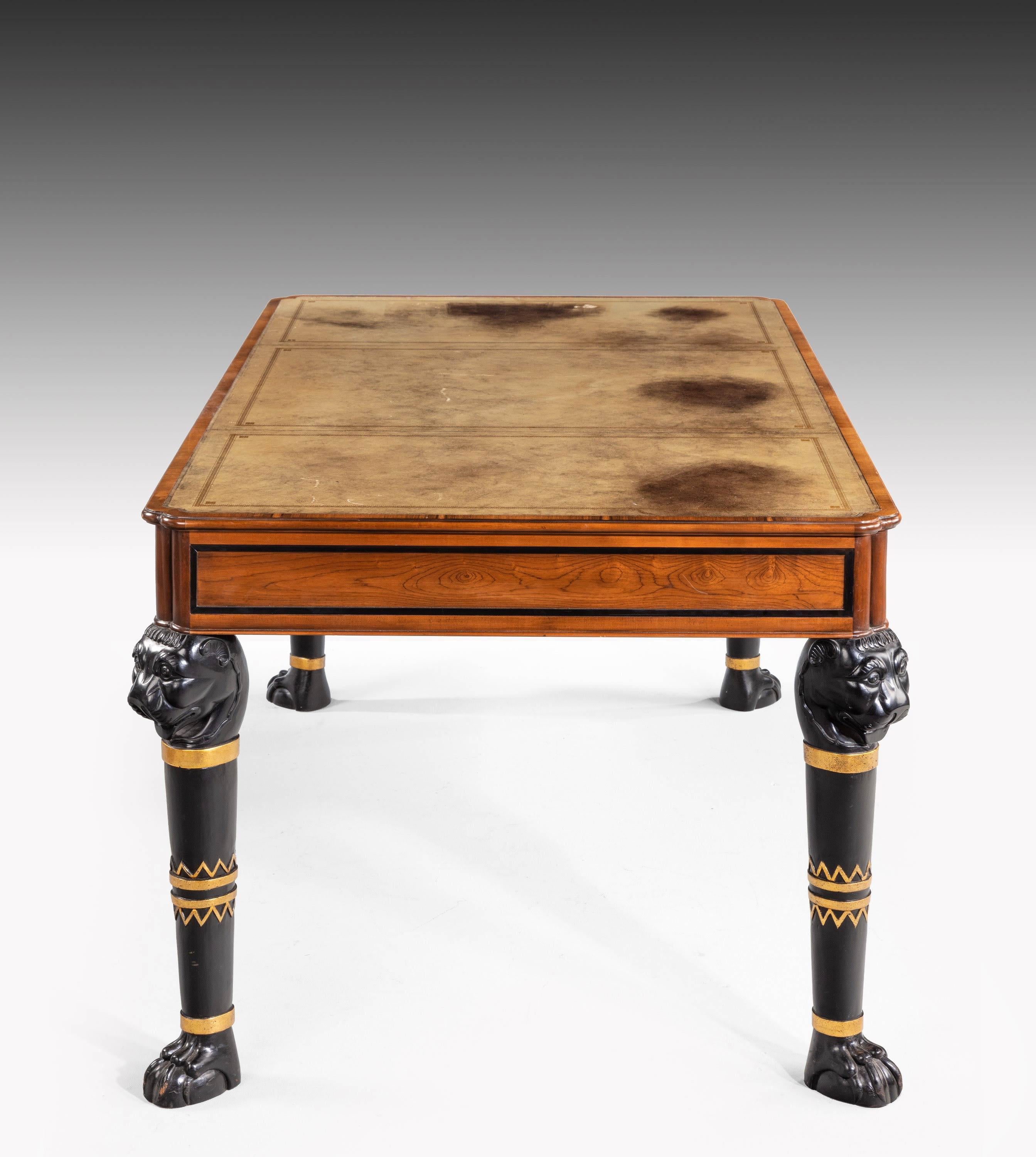 A handsome Regency style mahogany library table on Griffin supports with brass mounts.