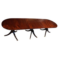 Regency style mahogany narrow triple pillar dining table