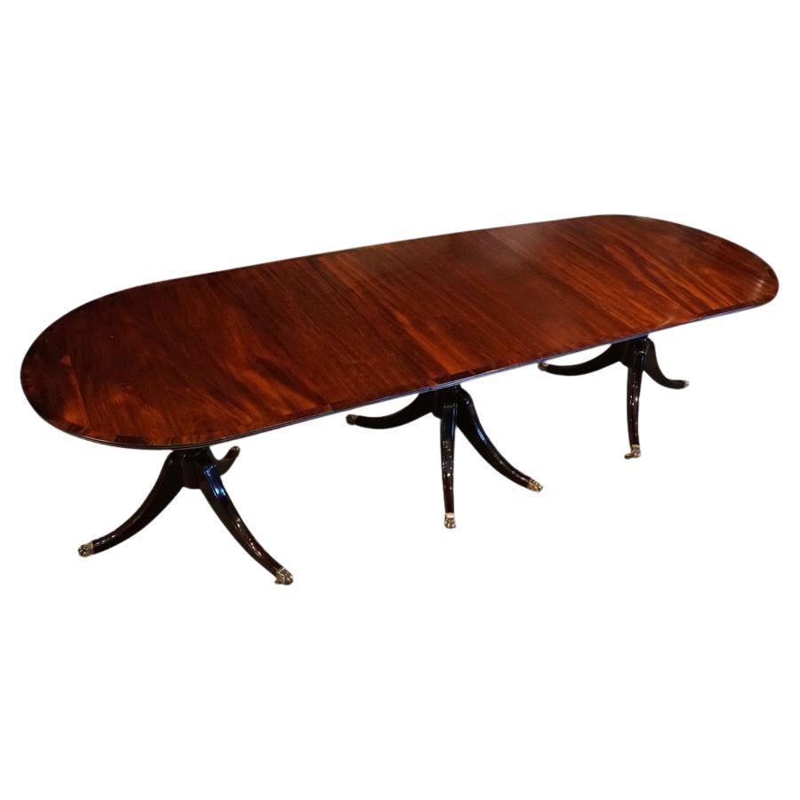 Regency style mahogany narrow triple pillar dining table  For Sale