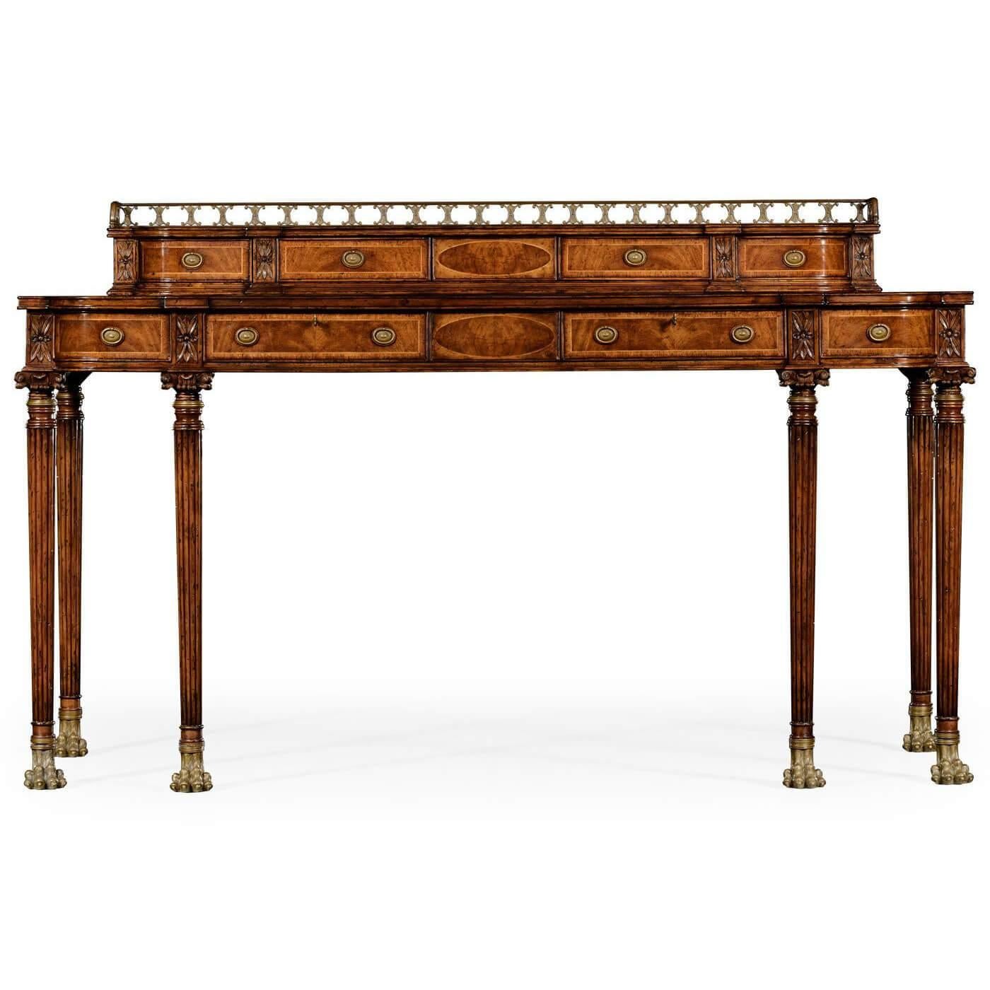 A large Regency style mahogany cross banded console server with a recessed upper section crowned with a finely pierced brass gallery, the bow fronted lower section with four shallow drawers and reeded legs with carved capitals and naturalistic brass