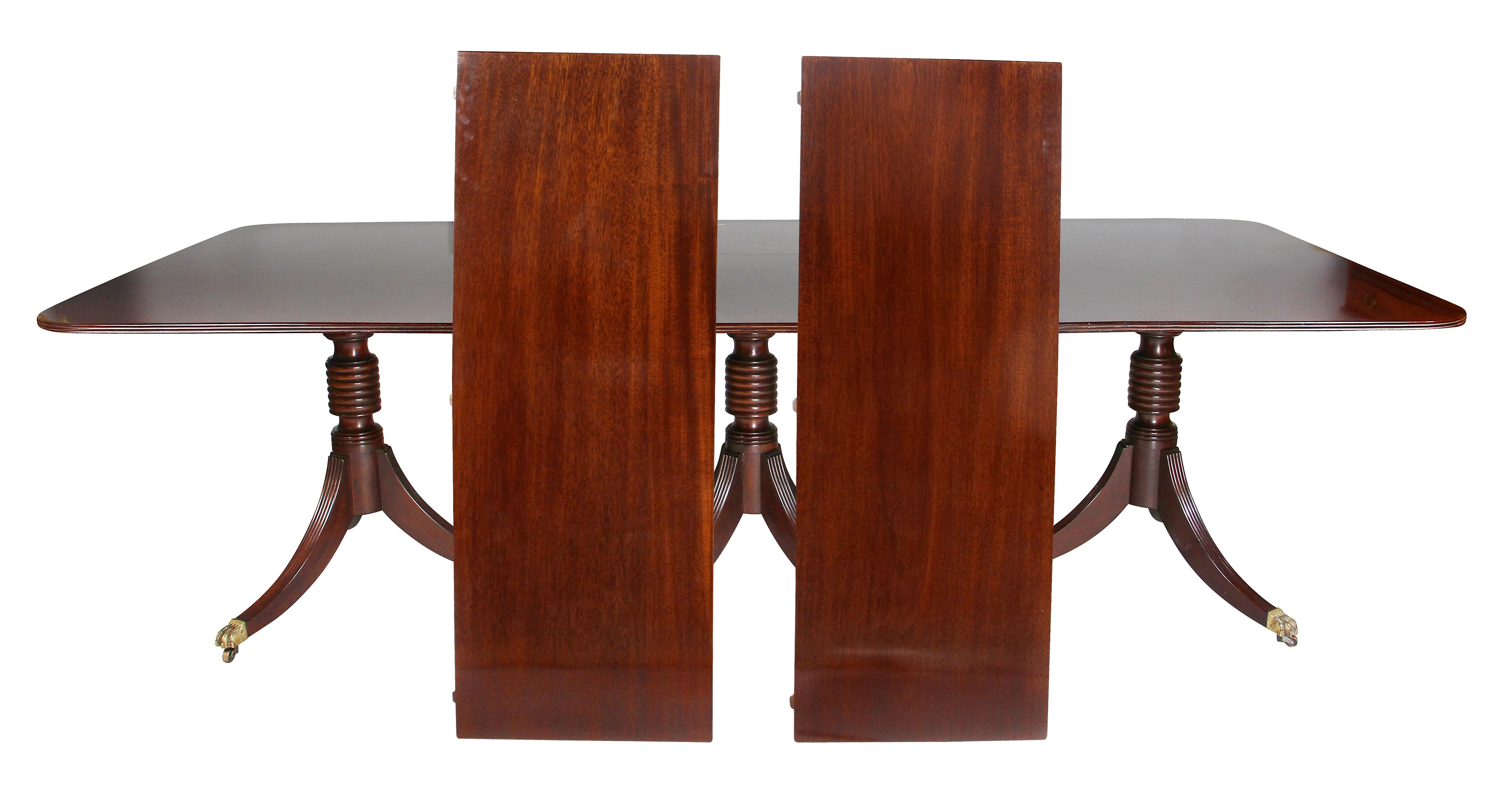 With a rectangular top with three sections and two leaves [not shown in feature picture]. Edge of top with reeded edge, three pedestals with reeded turnings raised on reeded saber legs and paw casters.