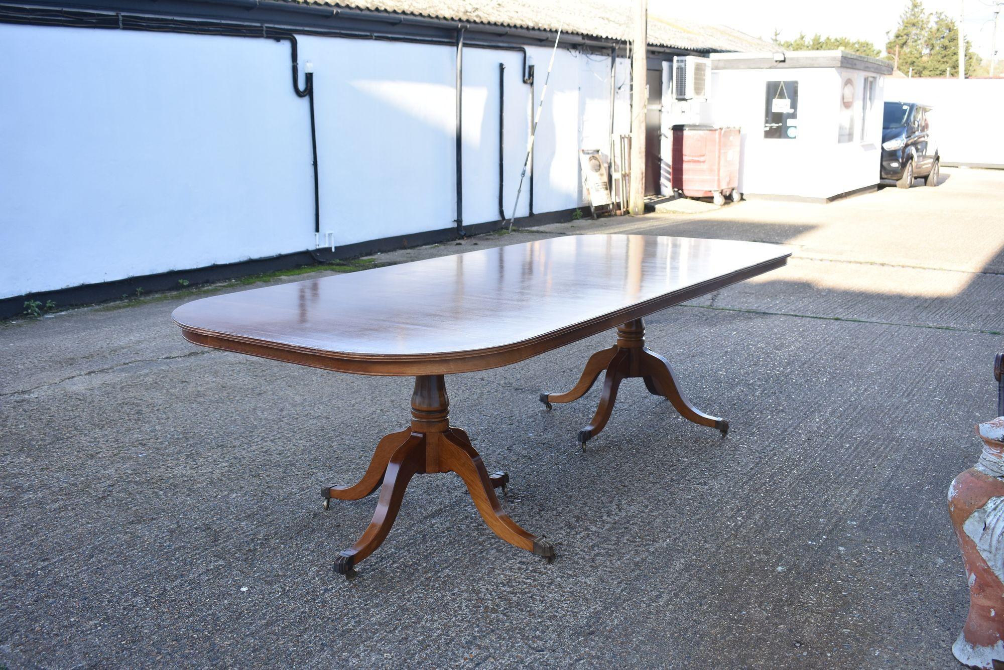 Mid 20th Century Regency Style Mahogany Twin Pillar Dining Table
This elegant Regency-style extending dining table, crafted in rich mahogany, dates from circa 1950s-1970s. Designed with classic period influence, it features a smooth, rounded-end