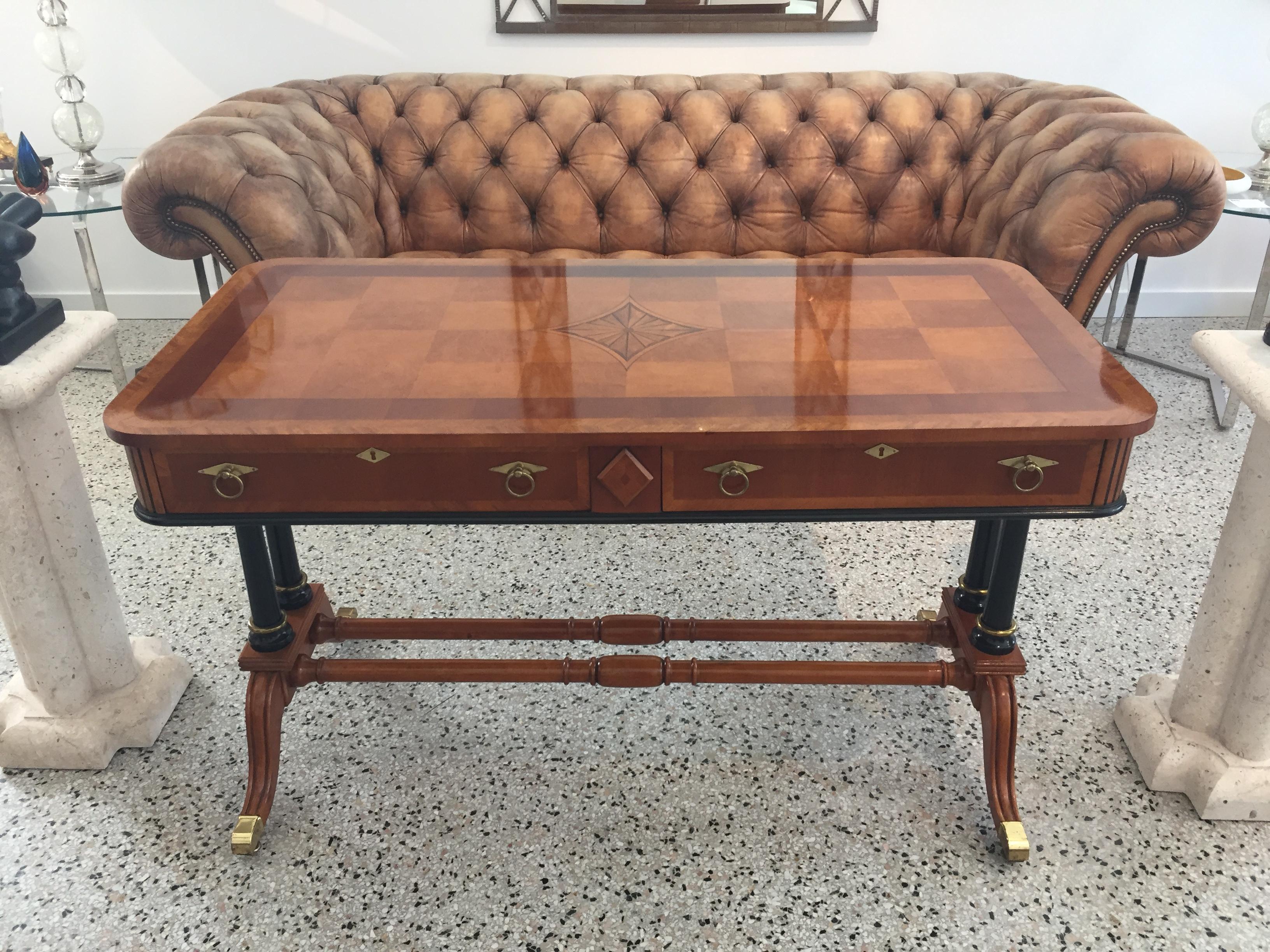 This stylish and chic Regency style console/library table dates to the 1980s and we belive was produced/sold by Heckman Furniture.  

Note: In the lead photo you will see to vertical shadows...those are reflections of a mirror on the wall behind the