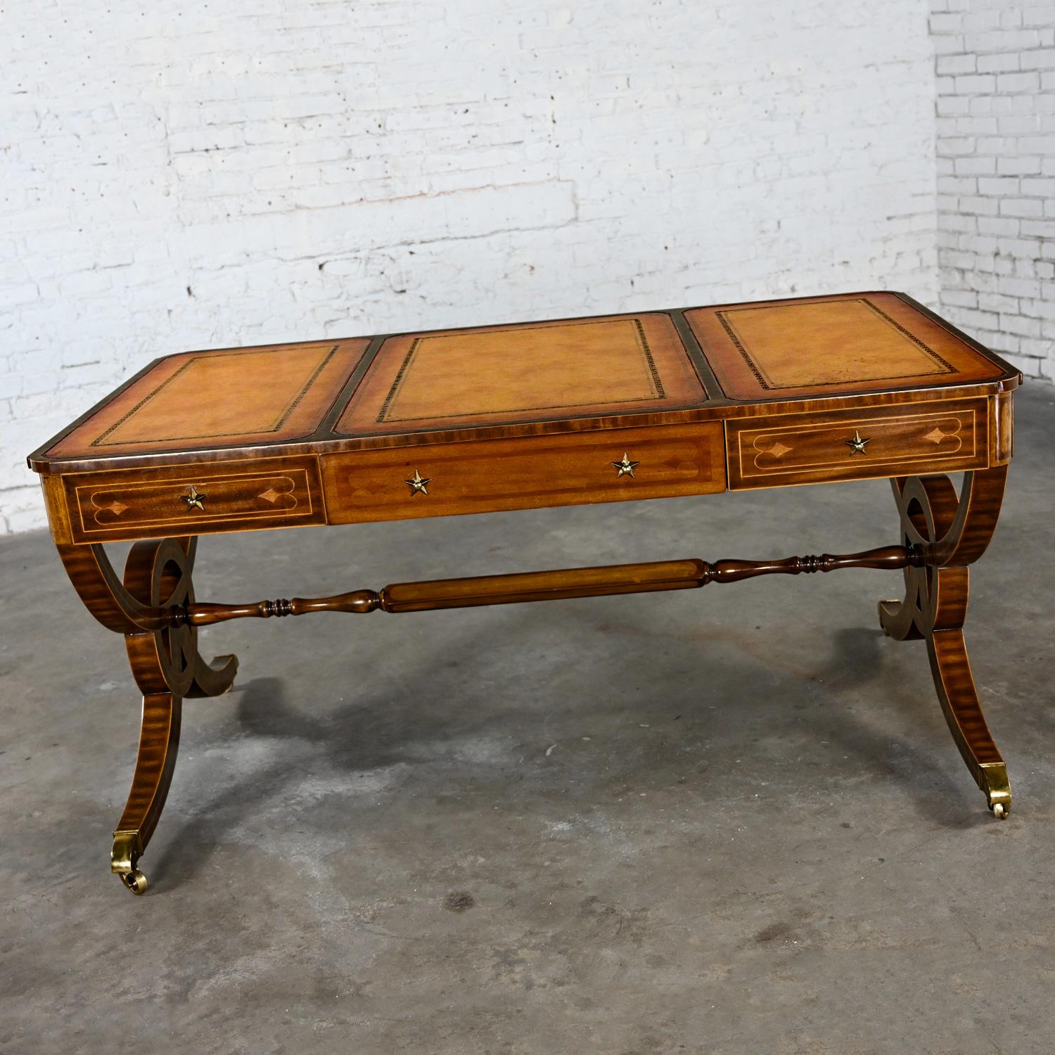 Stunning Late 20th Century Regency style faux partners desk comprised of a mahogany frame, embossed Florentine leather inset top, and brass details by Maitland-Smith. Beautiful condition, keeping in mind that this is vintage and not new so will have