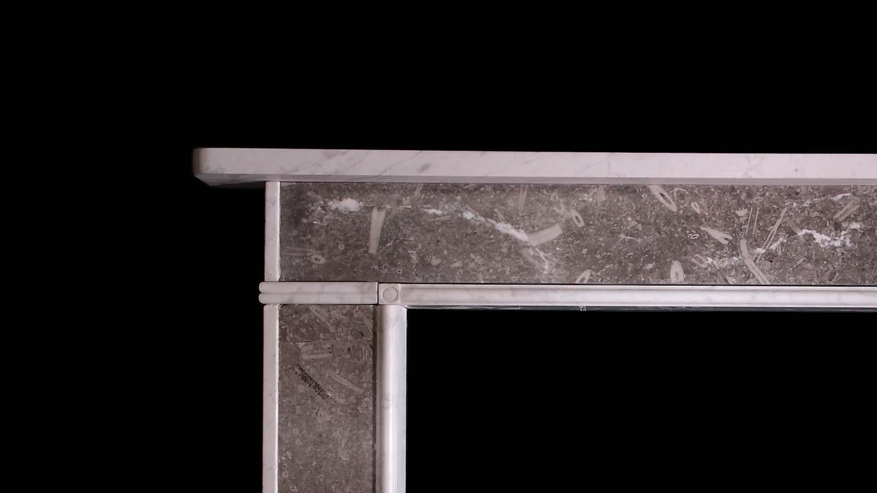 A Regency period chimneypiece of simple form in Derbyshire Fossil and Carrara marble.