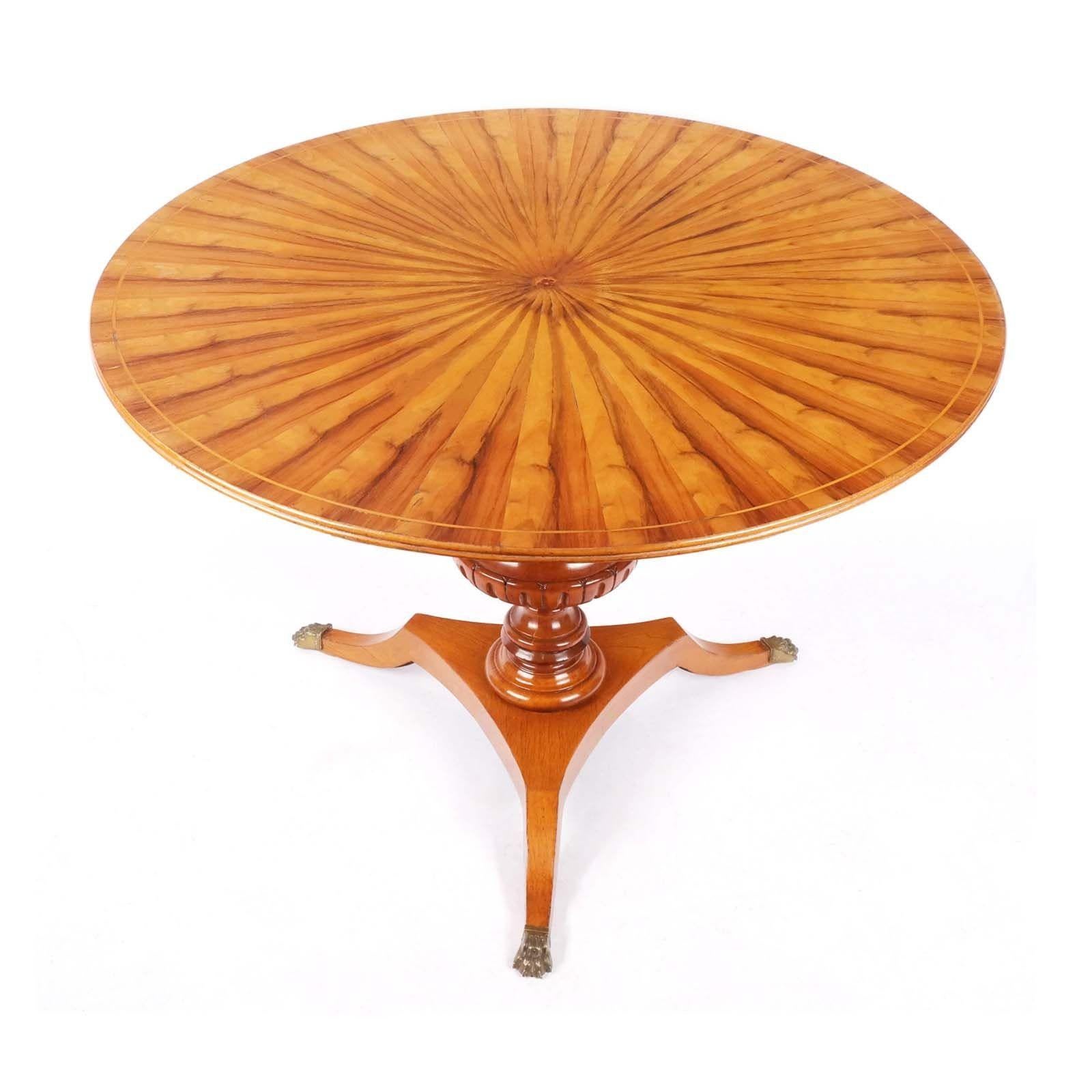 Regency-style maple and walnut table, the top with sunburst inlay raised on carved urn-form pedestal base on three lion paw feet. Made in France.
 