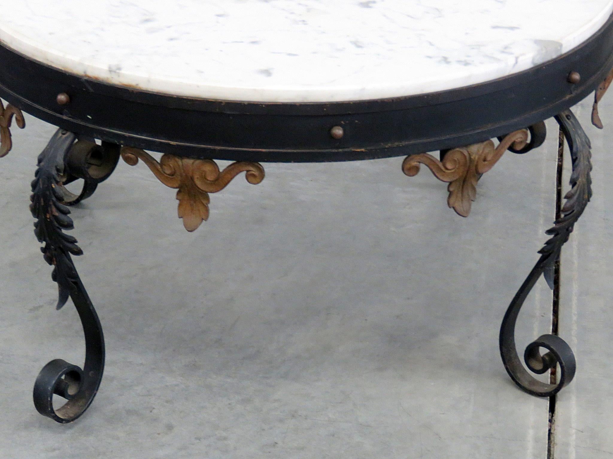 Regency style marble-top coffee table on a wrought iron base.