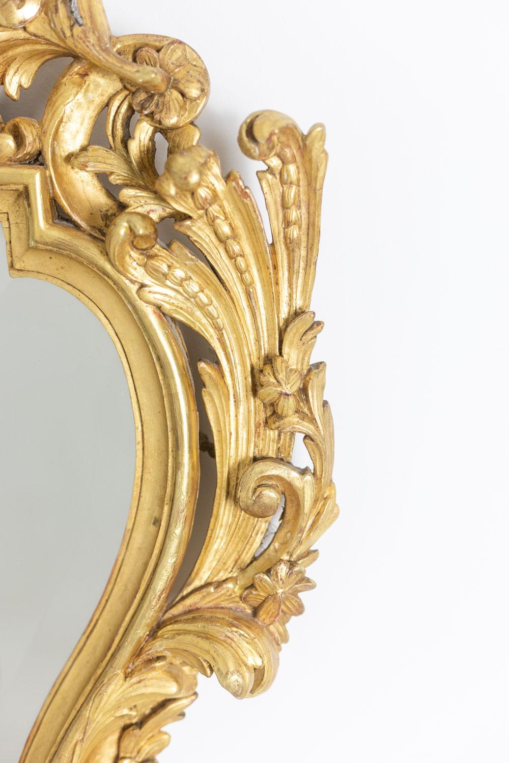 French Regency style mirror in carved and gilded wood. 1950s. For Sale