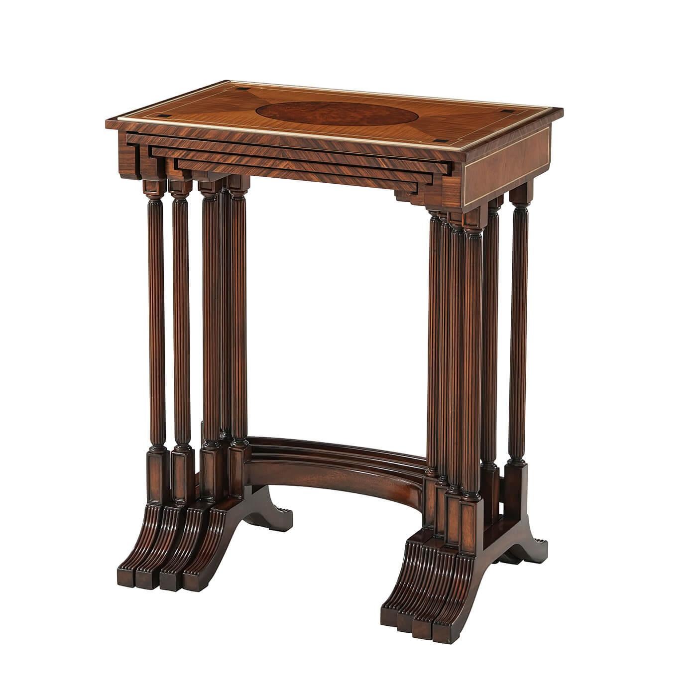 Regency style nest of tables a nest of four mahogany and inlaid quartetto tables, the rectangular tops each with an amboyna burl oval inlaid into Amarello veneer, strung with brass and with a brass moulding and rosewood crossbanding, above mahogany