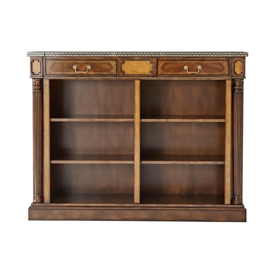 A walnut veneered low open bookcase, the rectangular yew burl crossbanded top with an ebony and brass inlaid edge, the frieze with two drawers flanked by yew burl panels, above two open sections each with two adjustable shelves, flanked by yew burl