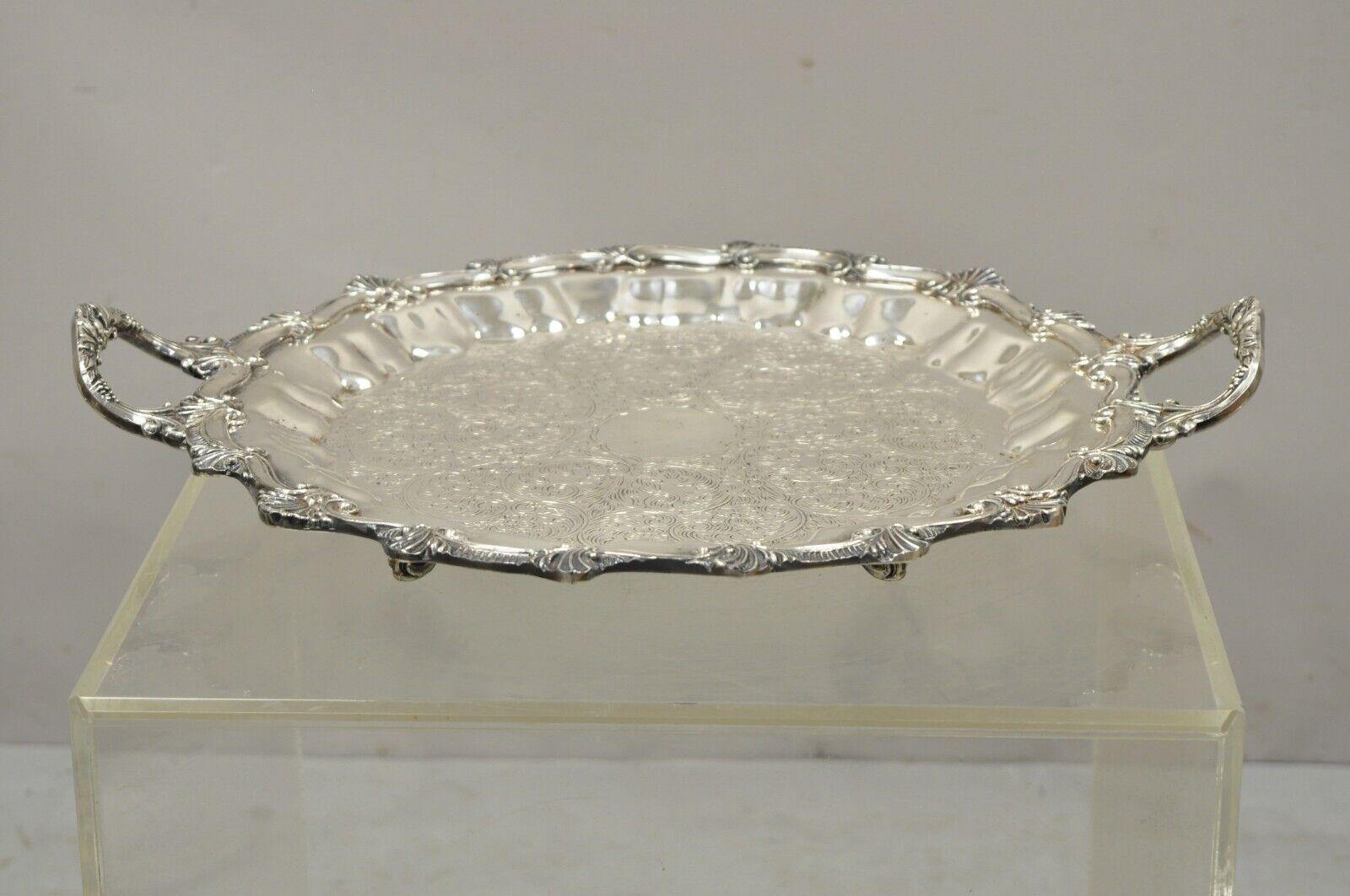 Vintage Regency Style Ornate Heavy Silver Plate Twin Handle Scalloped Platter Tray on Feet. Item features nice heavy weight, raised on twin ornate handles, scalloped edge with shells, engraved center, ornate feet, very nice vintage item, great style