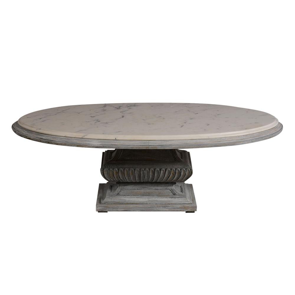 This 1950s oval Regency style cocktail table features the original large beveled Carrara marble top which is in excellent condition. The piece has an elegantly hand-carved wood pedestal base with a distressed gilt and hand-painted finish. This
