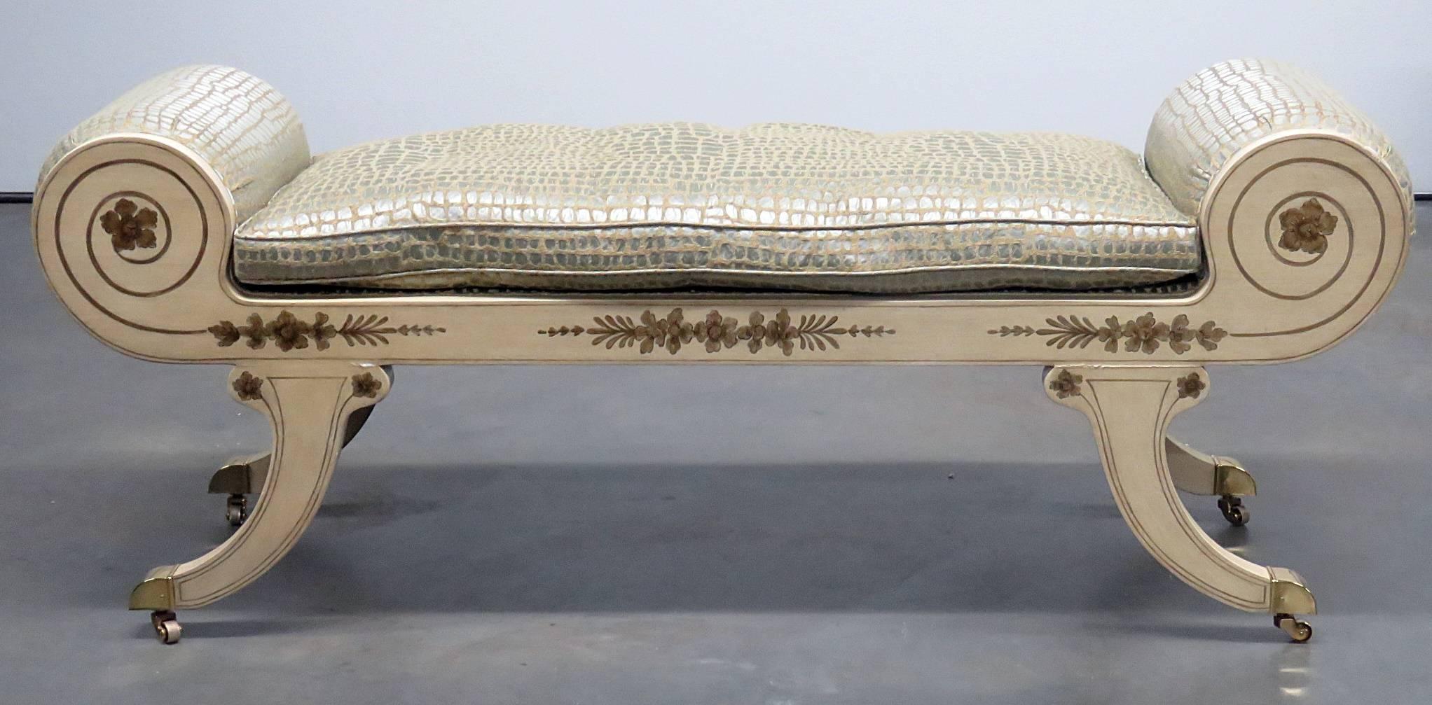 Regency style paint decorated window bench with brass feet and casters.
