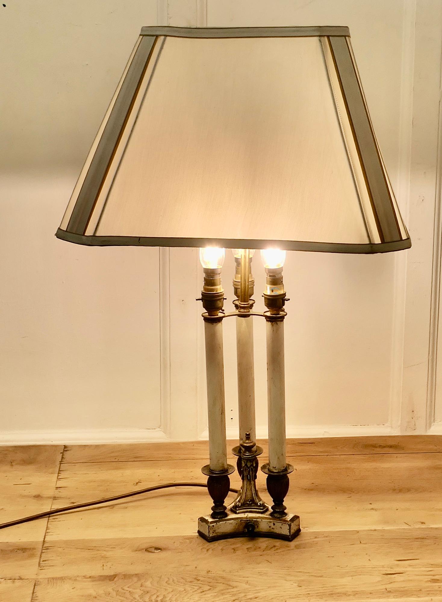 Regency Style Painted Brass Candle Lamp

This is a beautiful and attractive design, the lamp has 3 slender candles set on a 3 sided base, the lamps can all be switch on and off separately and it has a rectangular shade 

The lamp has relatively new