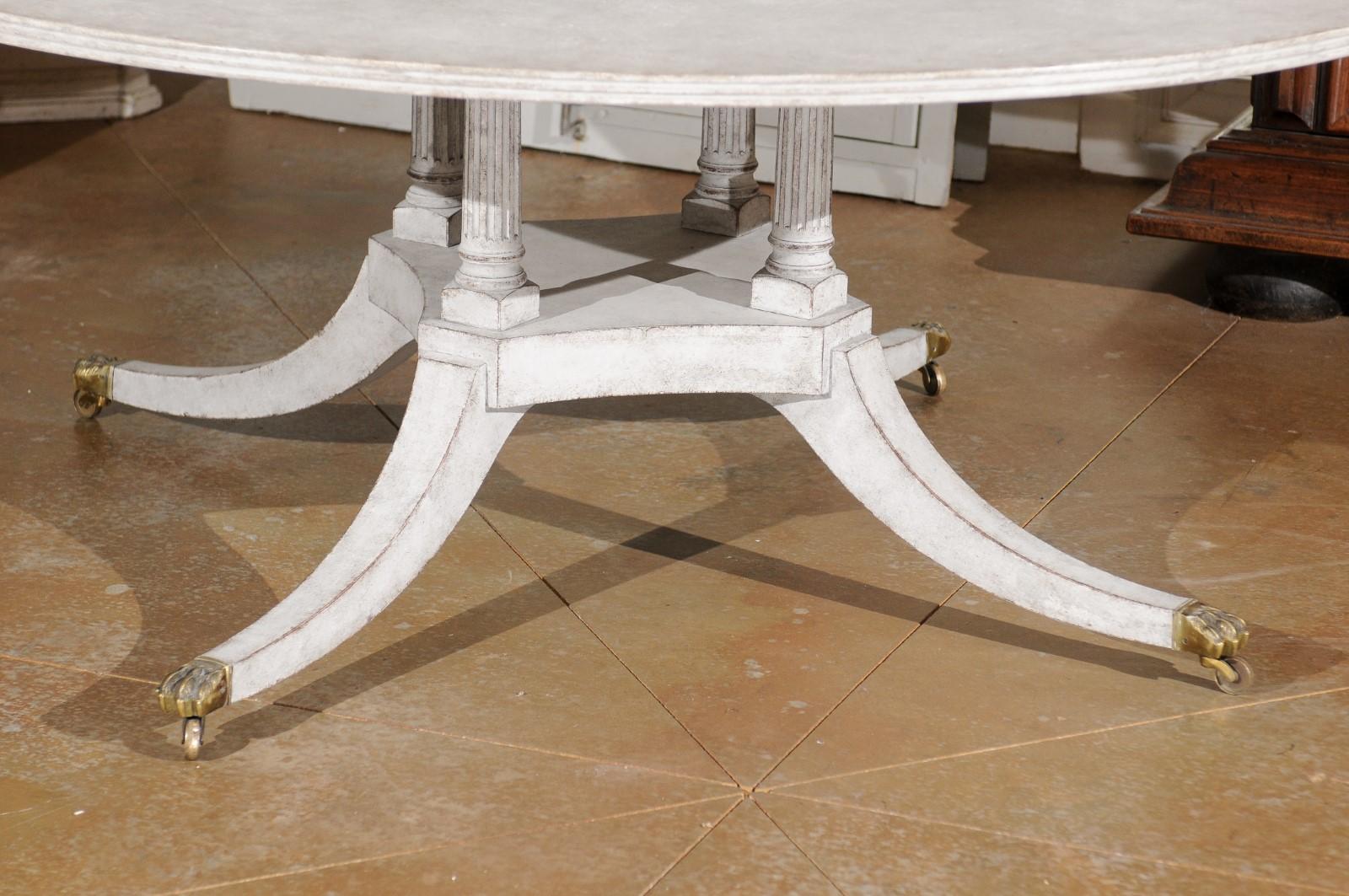 Regency Style Painted Wood Round Top Table with Brass Paw Feet and Casters 5