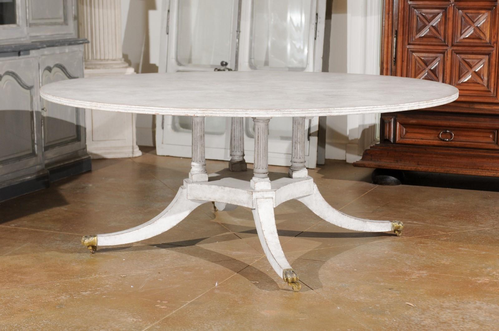 European Regency Style Painted Wood Round Top Table with Brass Paw Feet and Casters