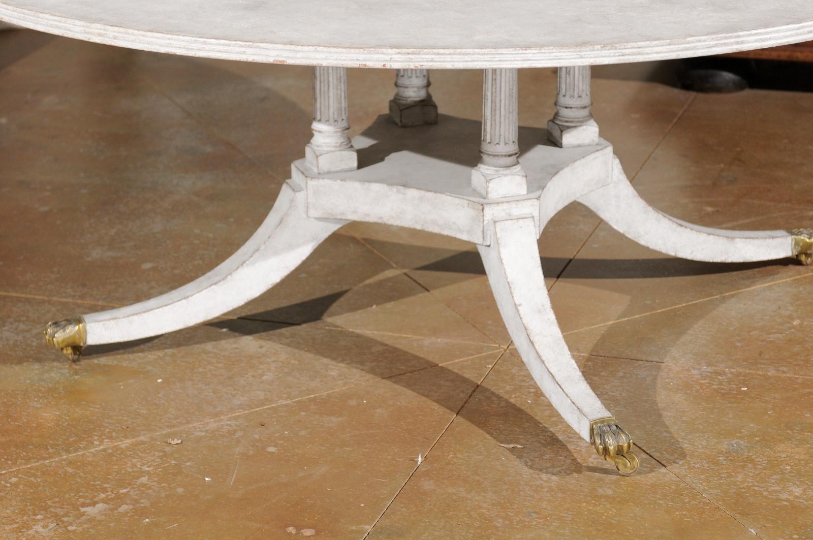 Regency Style Painted Wood Round Top Table with Brass Paw Feet and Casters In Good Condition In Atlanta, GA