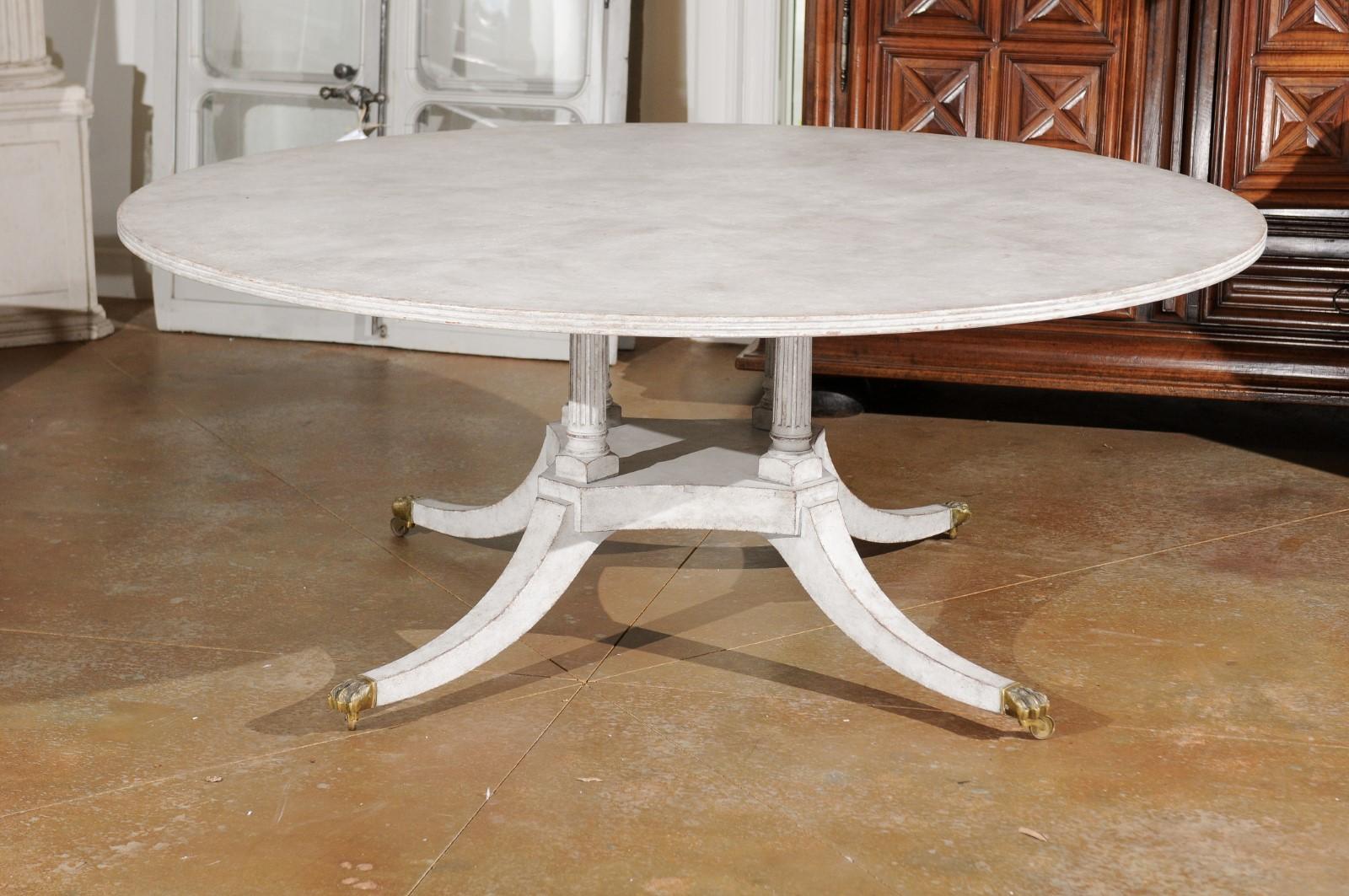 Regency Style Painted Wood Round Top Table with Brass Paw Feet and Casters 1
