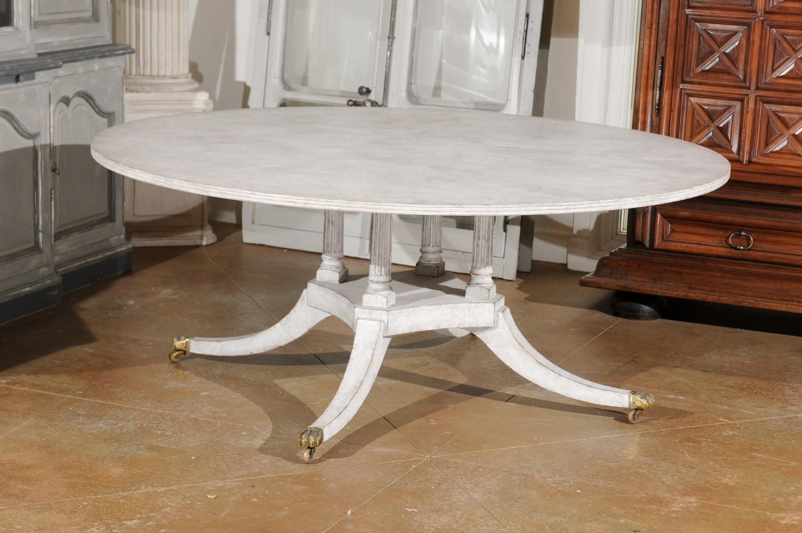 Regency Style Painted Wood Round Top Table with Brass Paw Feet and Casters 2