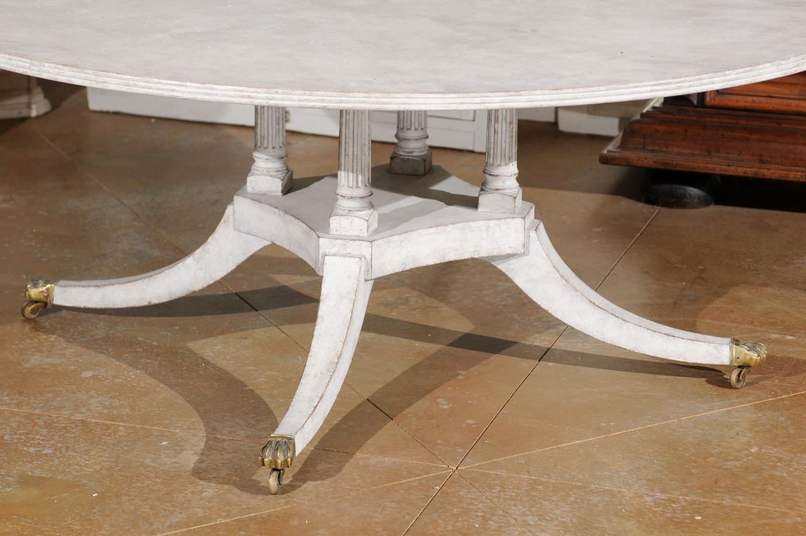 Regency Style Painted Wood Round Top Table with Brass Paw Feet and Casters 3