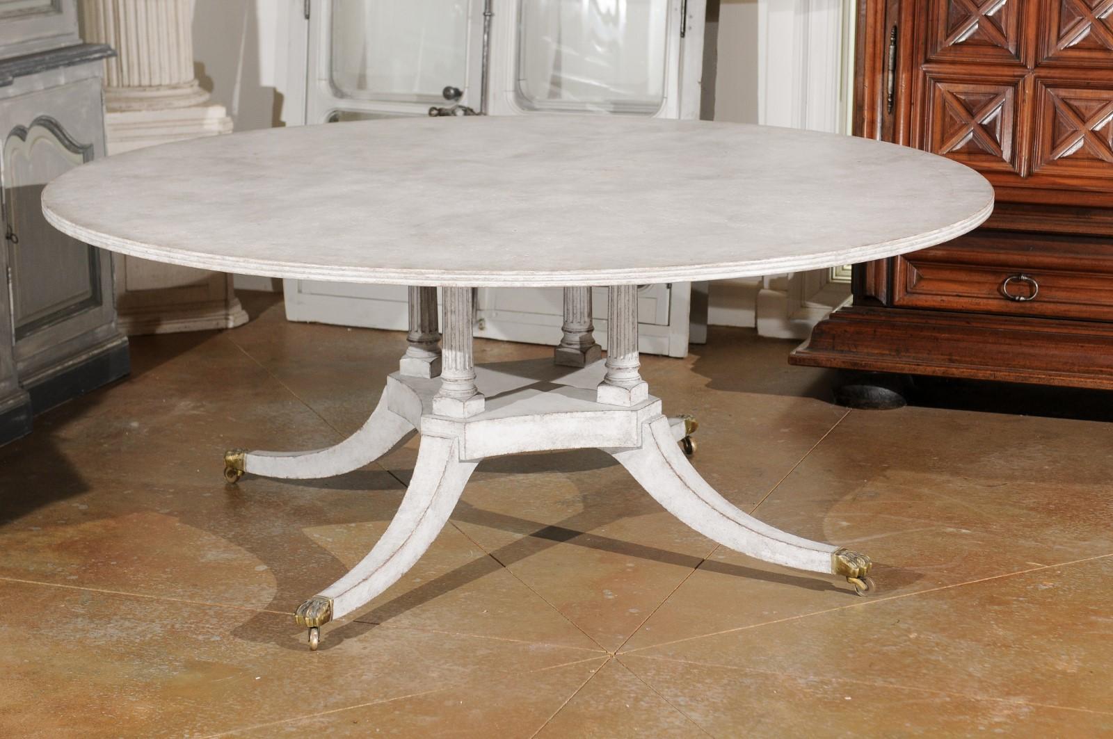 Regency Style Painted Wood Round Top Table with Brass Paw Feet and Casters 4