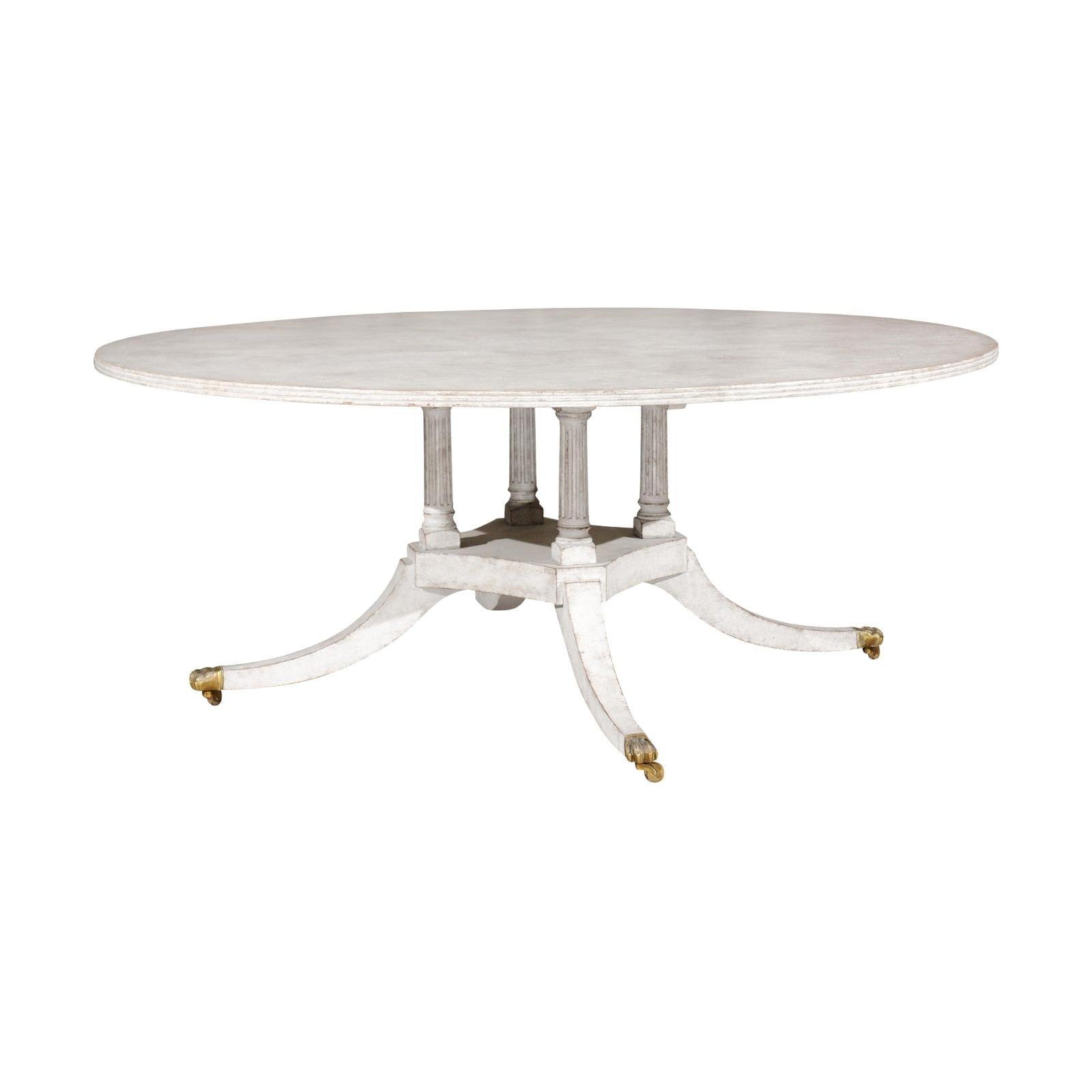 Regency Style Painted Wood Round Top Table with Brass Paw Feet and Casters