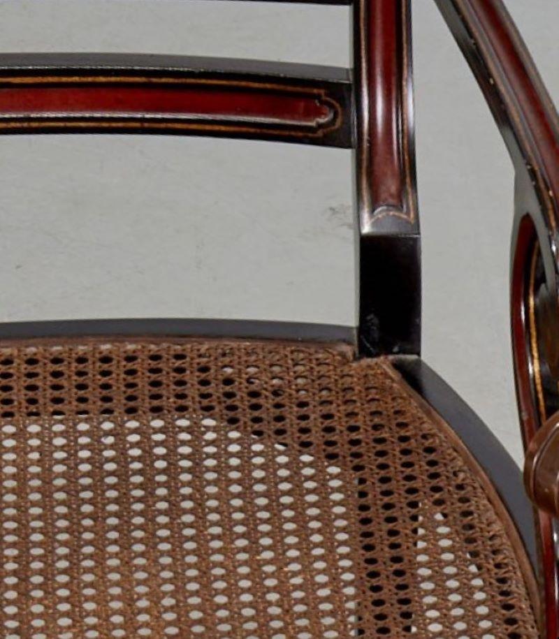 Menuiserie Fauteuil de style Régence en bois d'ébène avec assise en rotin, dossier avec détails en tête de lion en vente