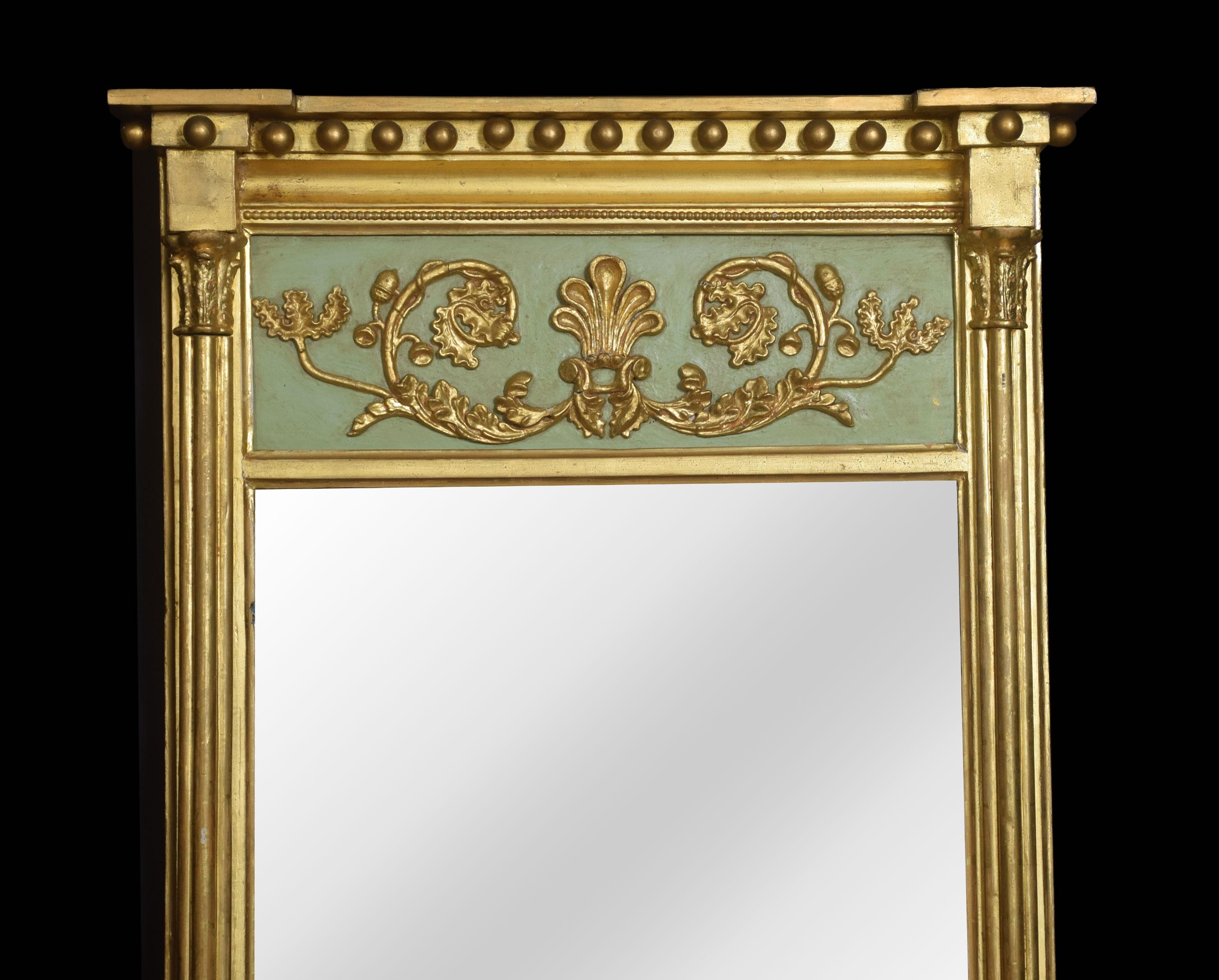 Regency style pier mirror, of rectangular form, the moulded top above moulded ball decoration to the painted panel applied with gilt relief decoration, above the original mirrored plate, within a gilt moulded border.
Dimensions:
Height 42