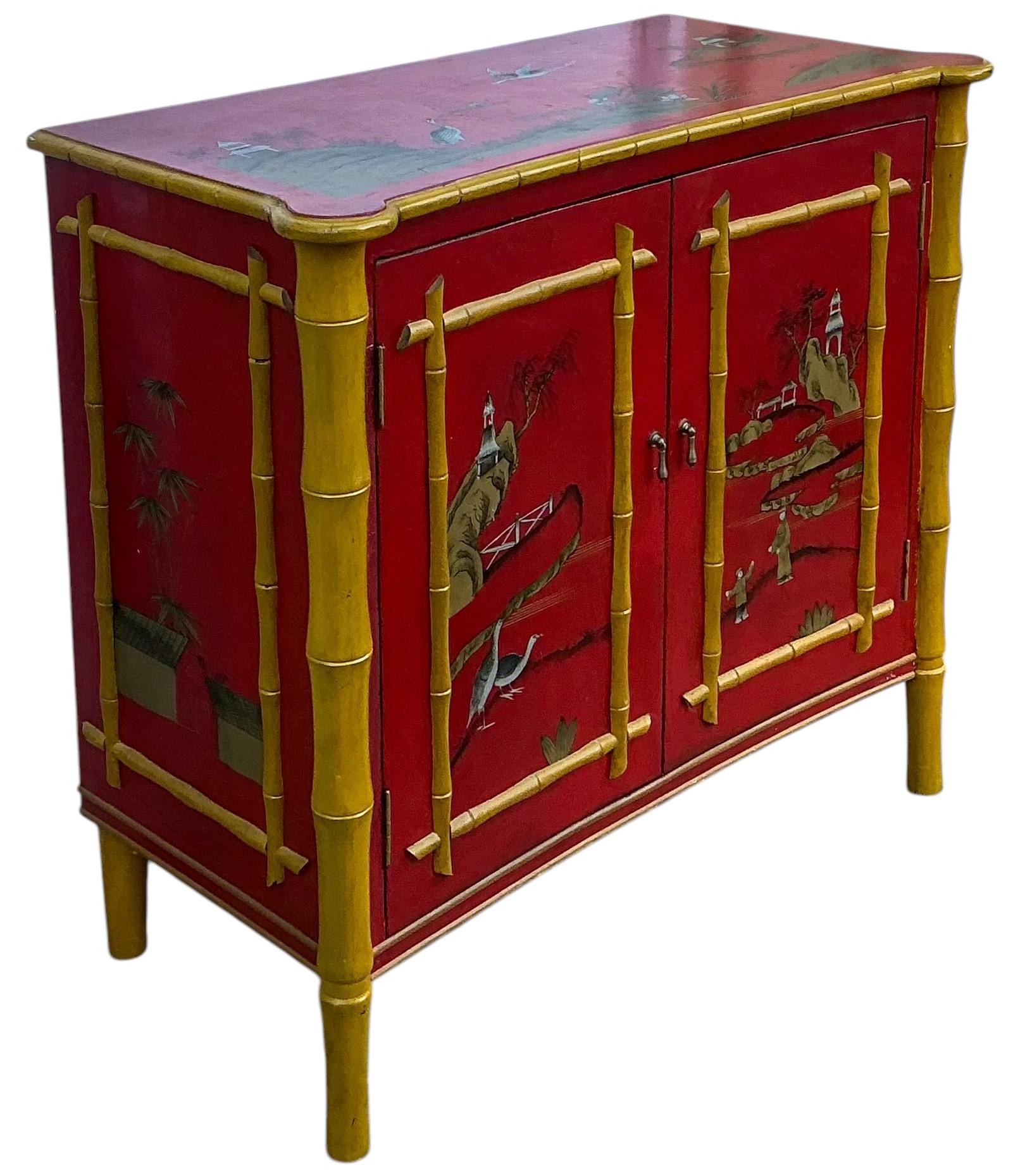 Perfect for that powder bath! This is a red lacquer chinoiserie cabinet with gold faux bamboo accents. The cabinet opens to a single shelf. It is in very good condition and unmarked.
