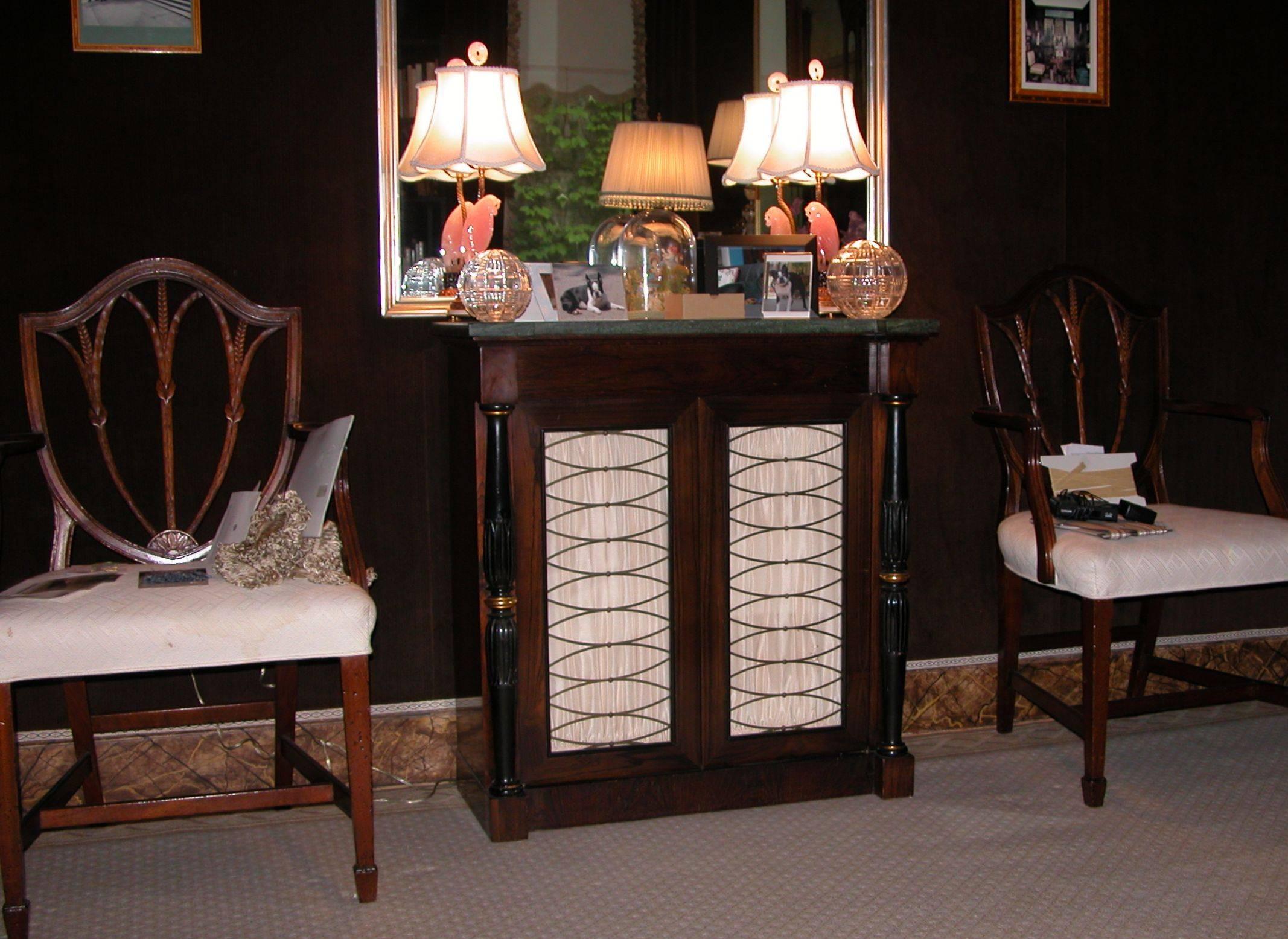 Two-door cabinet with drawer and Verdi Green marble top, original silk curtains behind brass elliptical screen. Pair of full round carved and black lacquered columns sit forward on the front corners of the cabinet. The interior depth behind the