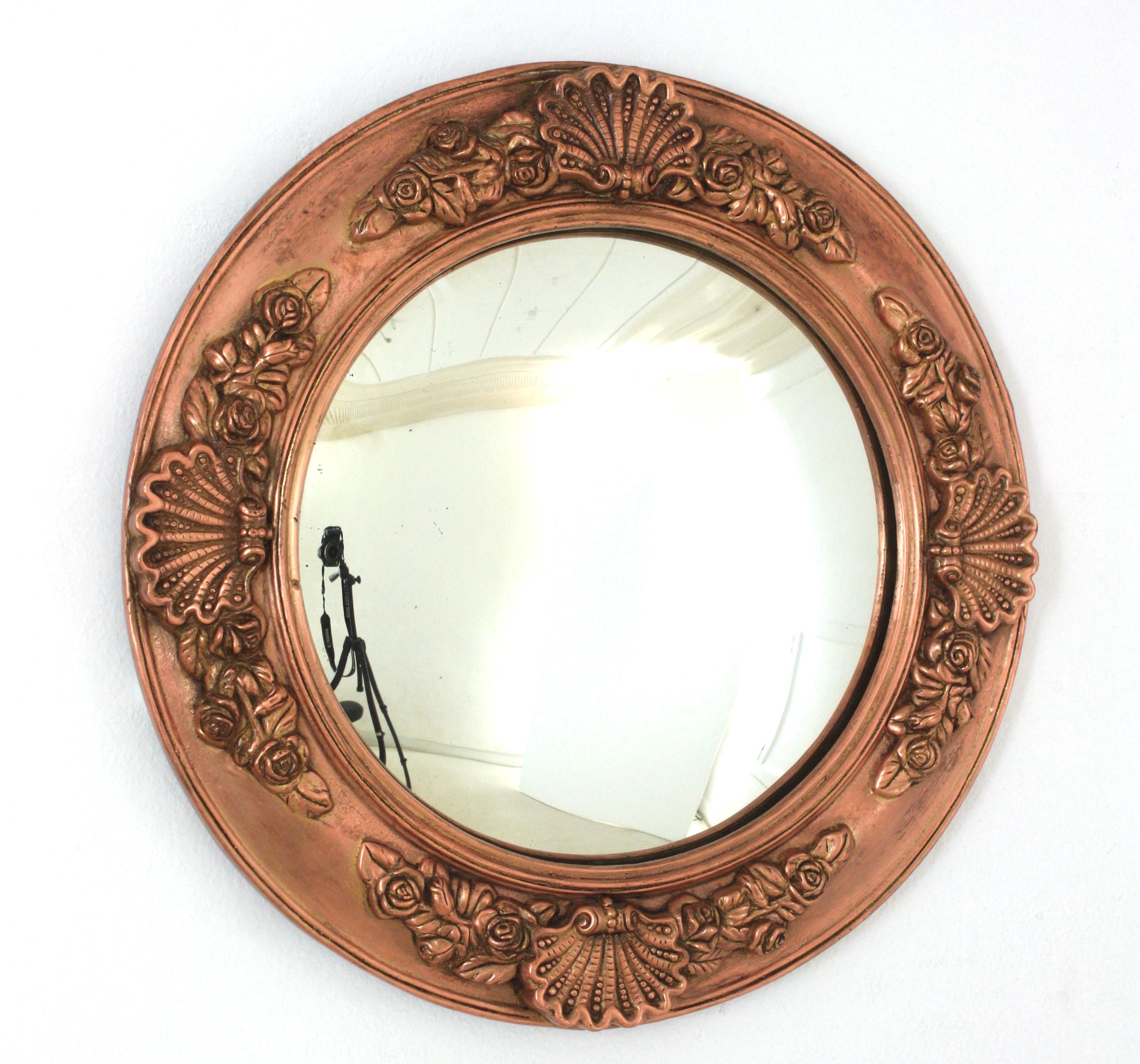 English Regency Copper Framed Convex Bullseye Mirror

English Regency Molded Copper Round Convex mirror with Foliage, Floral and Shell motifs. England, 1930s.
A gorgeous Regency copper round convex mirror made of wood covered with copper relief