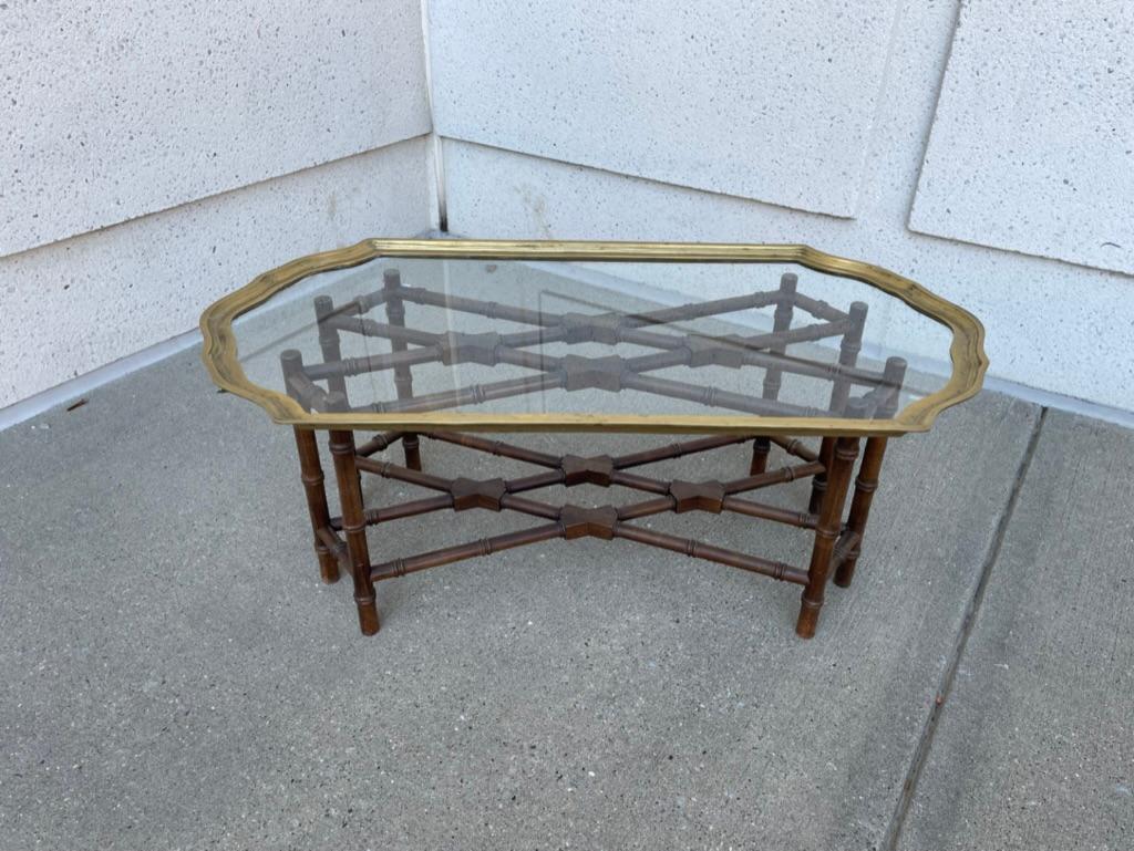 Great looking Regency style small scale coffee table, perfect proportions for an apartment or guest room. The heavy gauge brass shaped top sits on a faux bamboo base. A very appealing design that fits any interior, contemporary or antique.