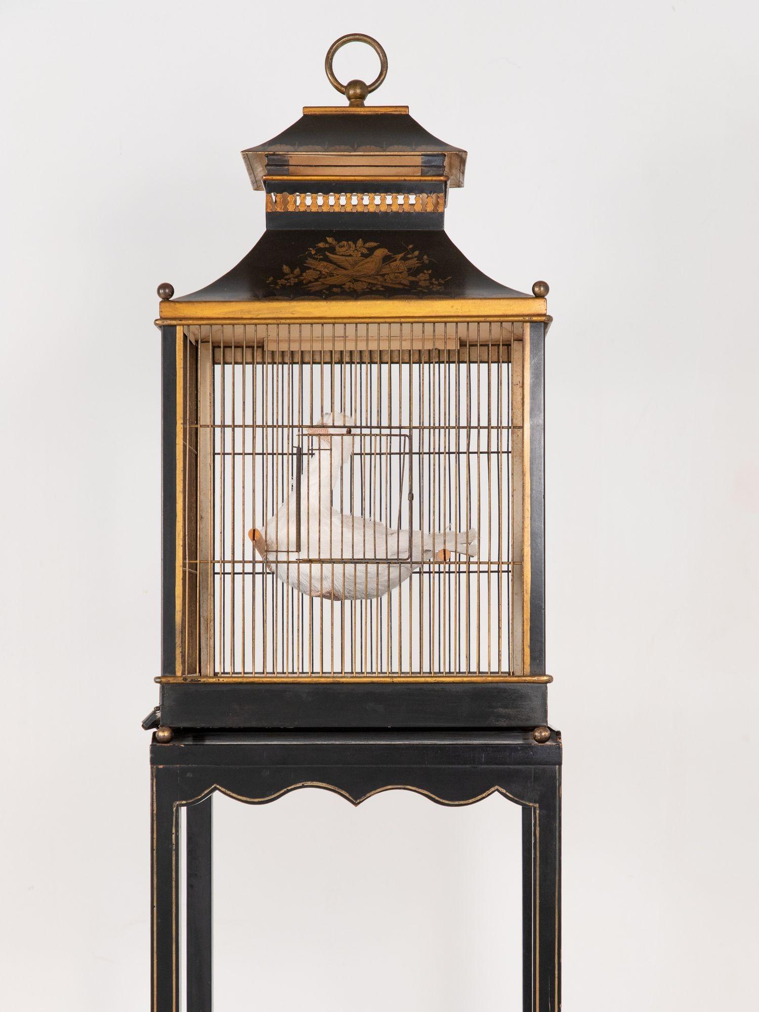 This 20th-century Regency Style birdcage is a romantic tribute to a time when beauty graced even the most functional objects. Crafted in painted toleware, it showcases delicate detailing and neoclassical lines inspired by early 19th-century British