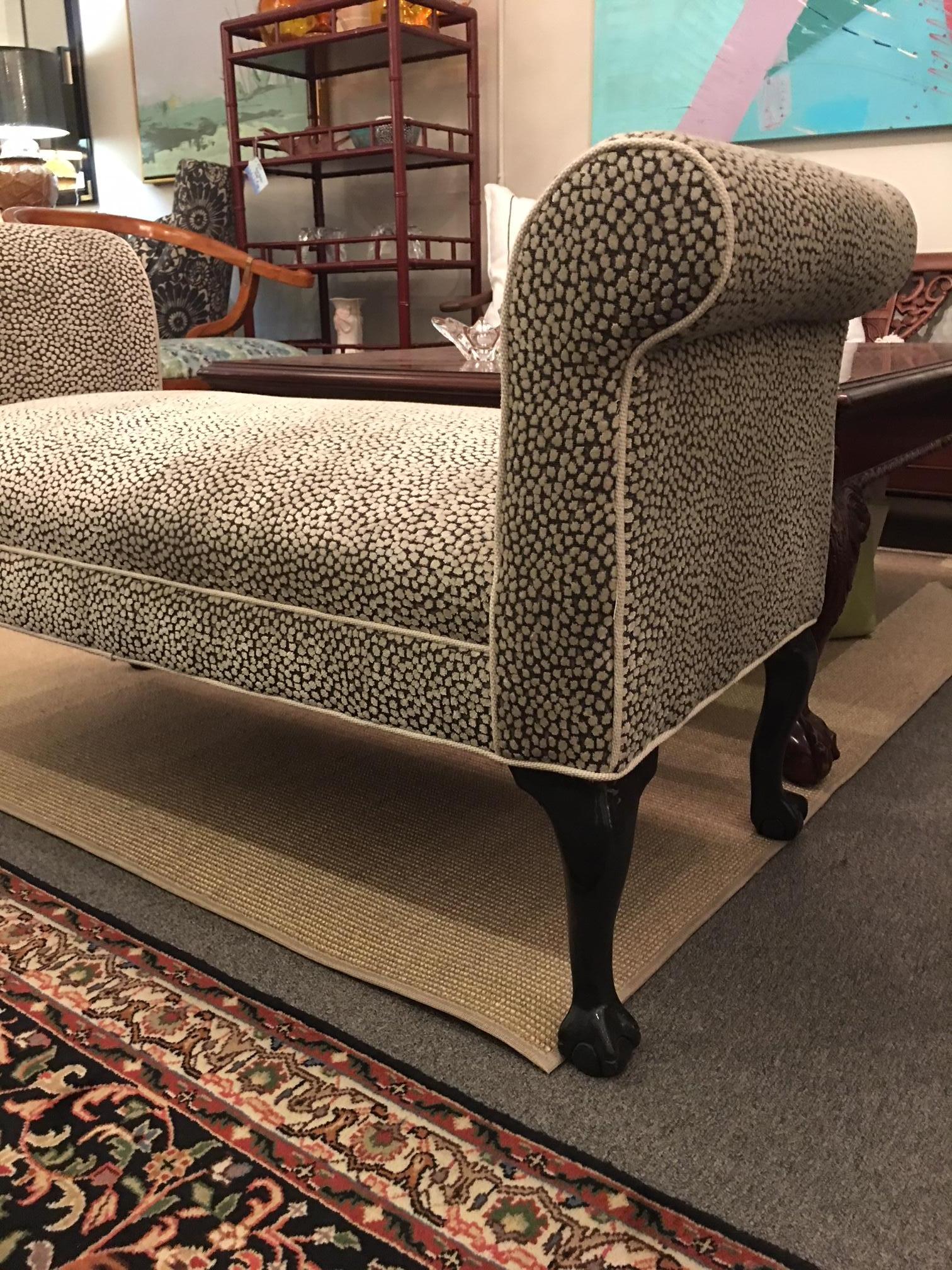 This vintage bench has been reupholstered in a cool velvety fabric that is reminiscent of an animal print, but understated. It is corded in tan linen. Lacquered legs in Contessa's Cape. Claw and ball foot.