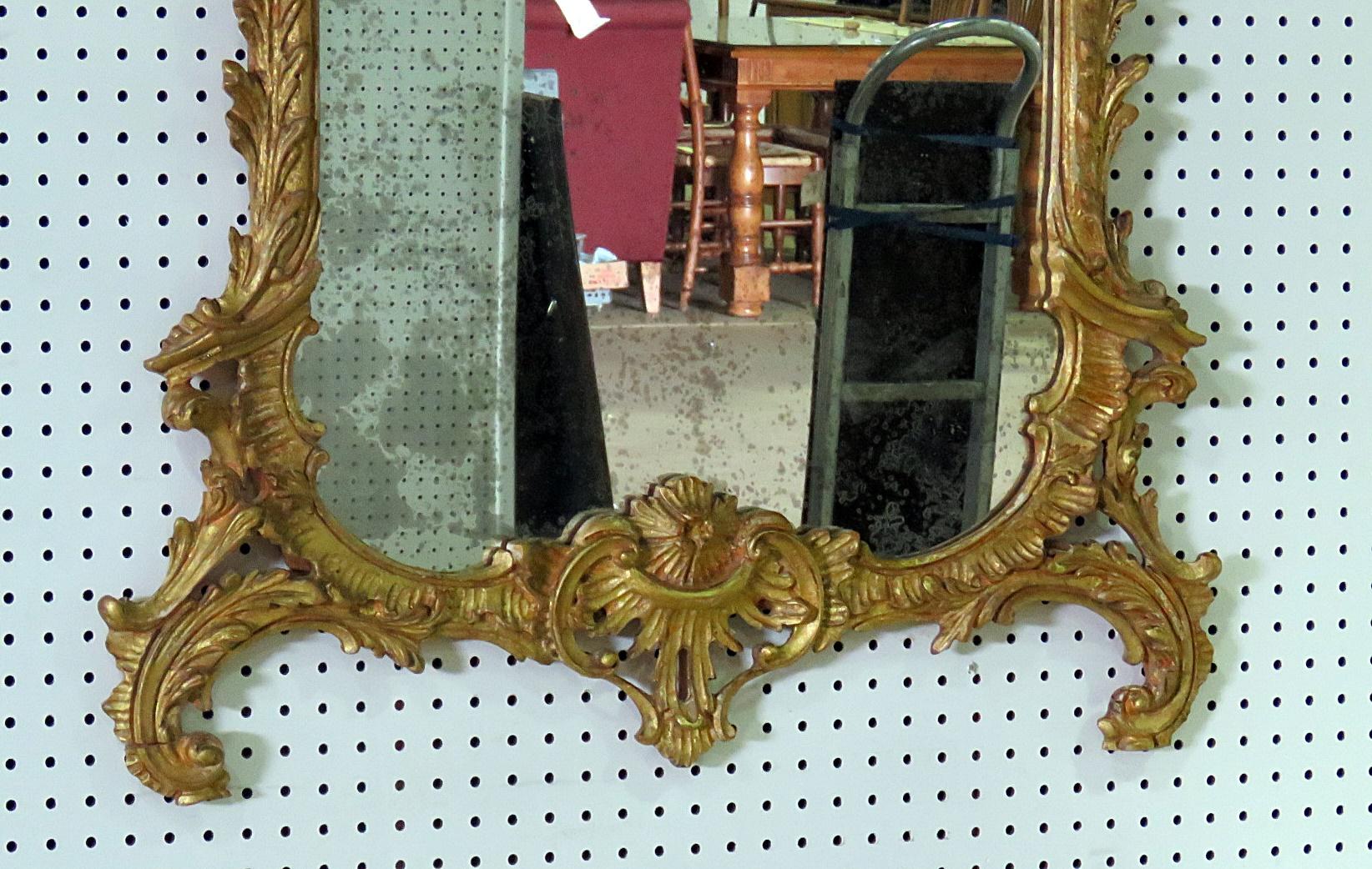 Regency style wall mirror with a distressed finish.