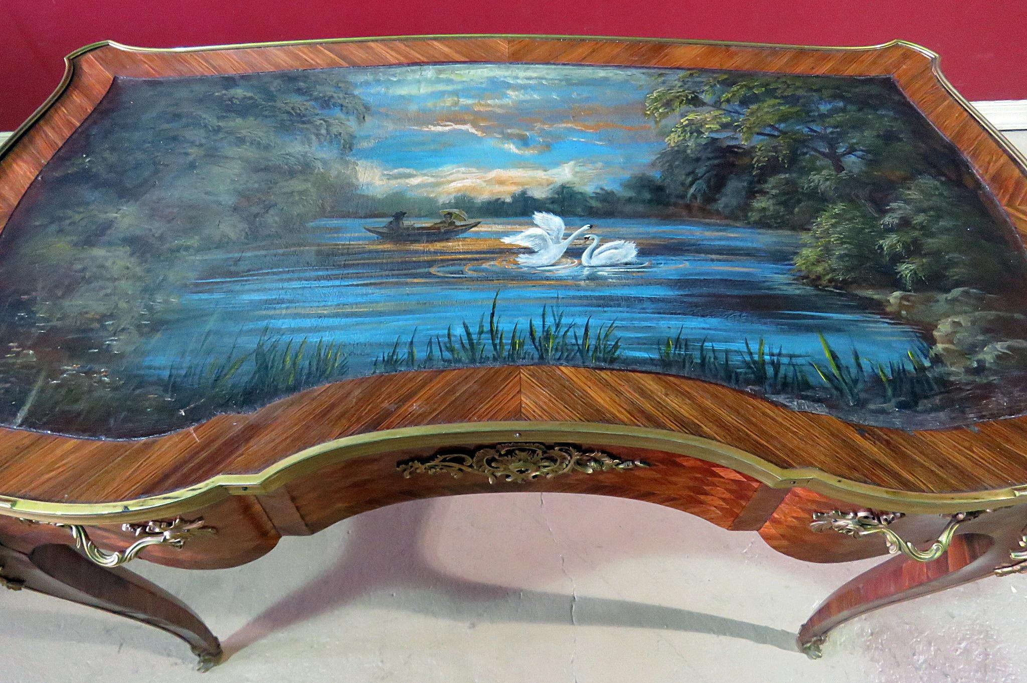 Regency style 1 drawer inlaid writing desk with a professionally hand-painted swan scene on a pond at night on a leather top and superb brass mounts. This desk was just professionally painted and shows no wear to the painted surface. It's a unique