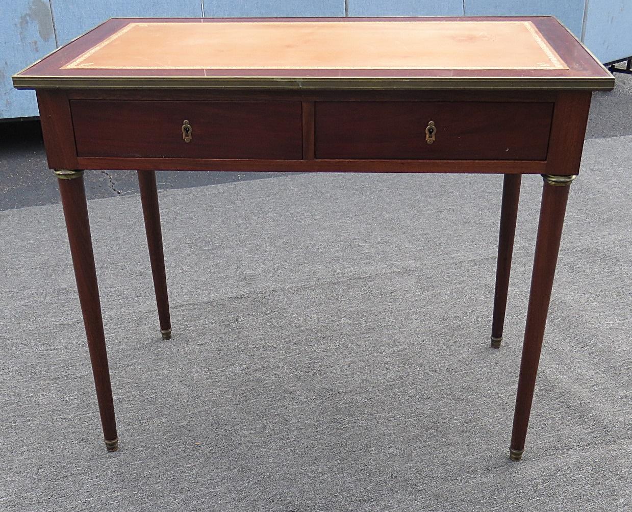 Regency style leather top two drawer desk with bronze accents.