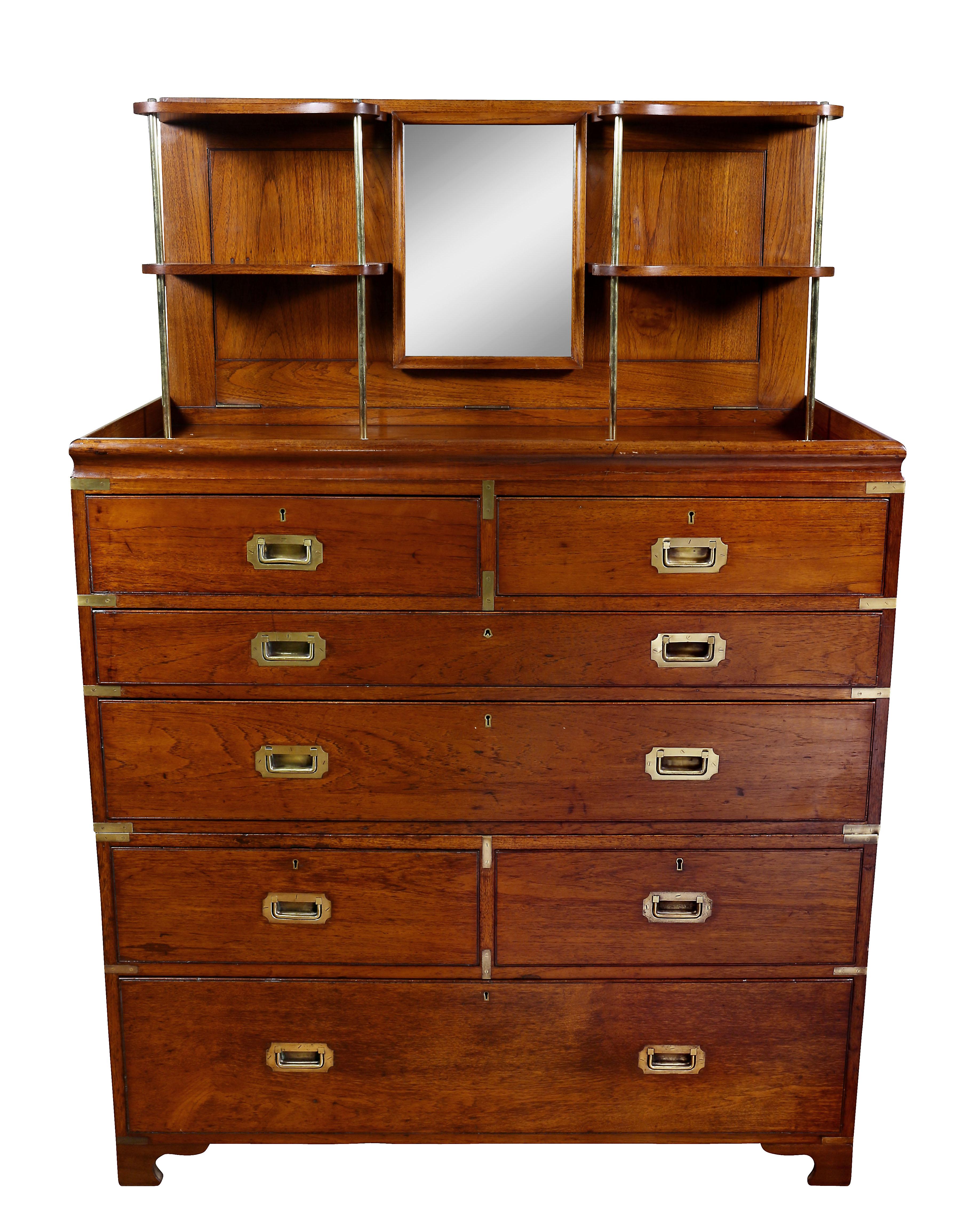 Of unusual fine quality and scale. The rectangular top with panelled hinged lid opening to a shelved and mirror interior, over two drawers over a pull-out drawer with fitted desk over over a long drawer over two drawers over a long drawer, shaped