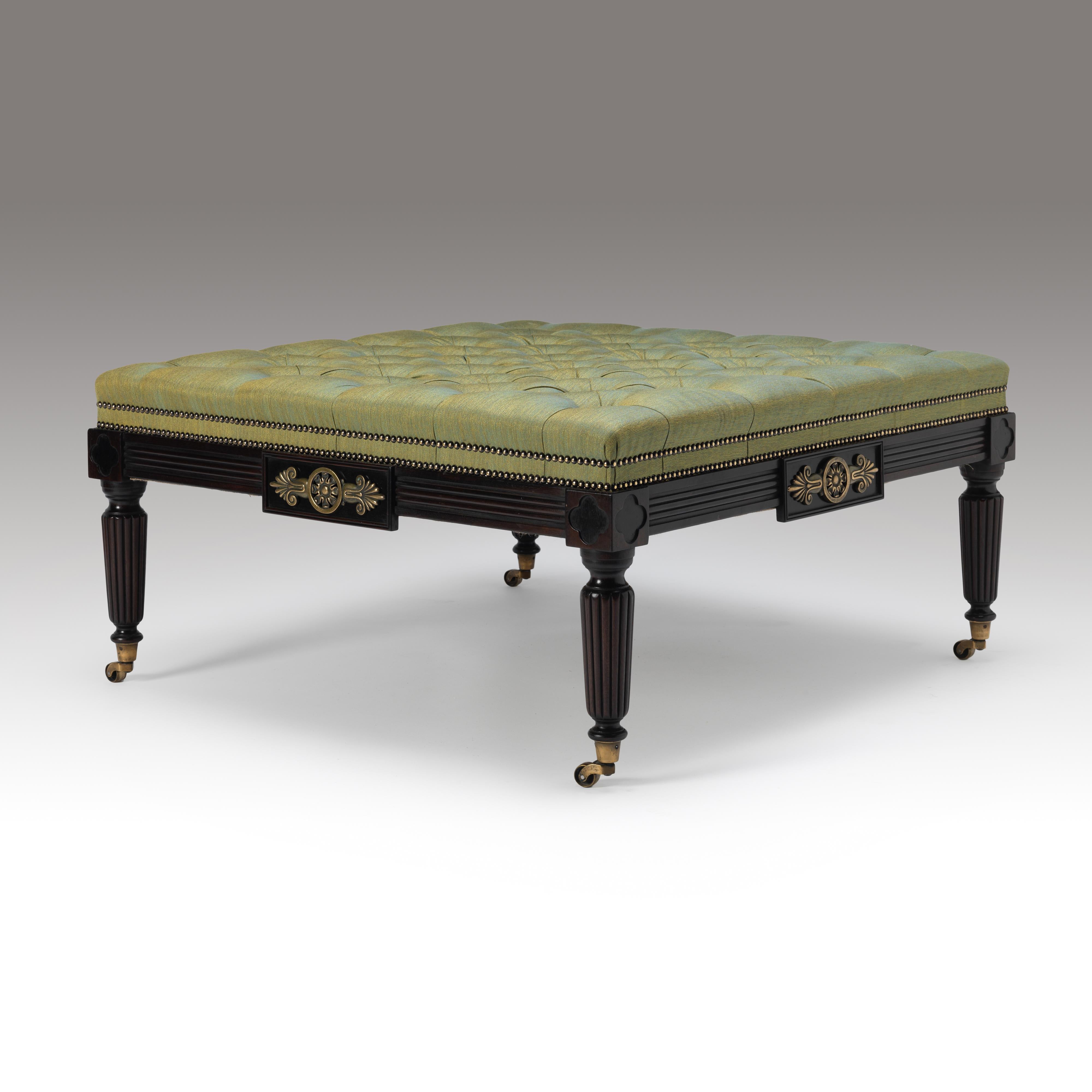 A finely carved and reeded stool of square form, a central panel with gilt bronze mounts and quatrefoil corner paterae on brass castors. To be upholstered in the client’s own material. Bespoke sizing, design adaptations and finishing available.