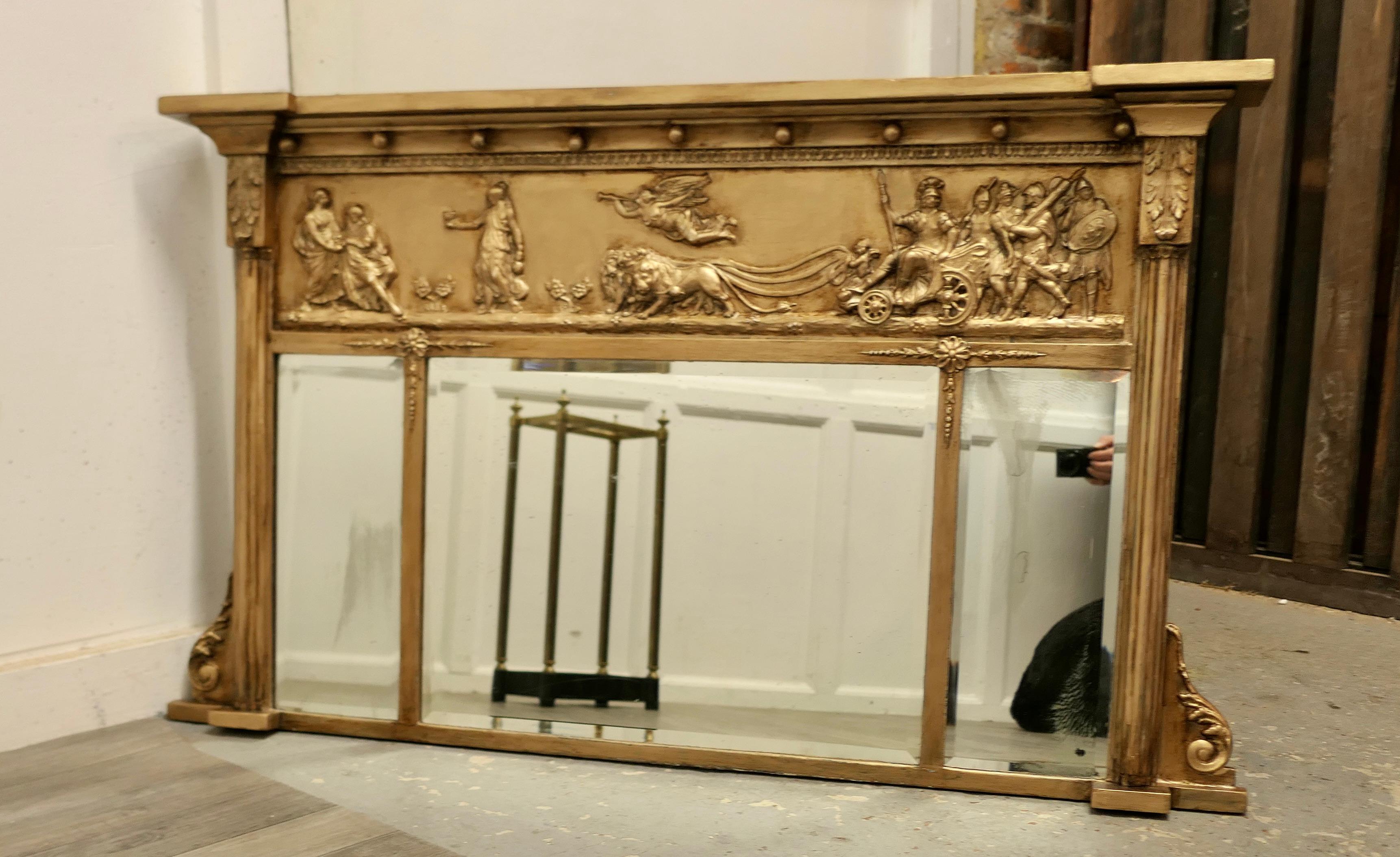 Regency triple plate gilt mirror or over mantle 

The Regency carved Frame is a rectangular shape, it has corinthian columns at either side and a neoclassical scene in Gesso along the top, depicting Gods and chariot racing The mirror has three