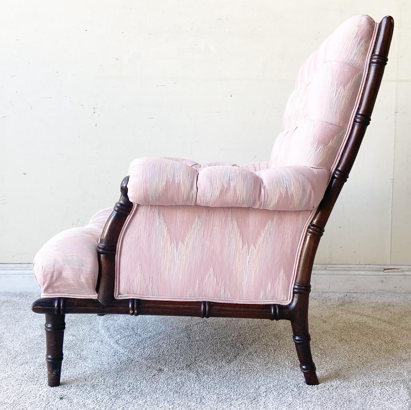 Exceptional boho chic/regency lounge chair with Ottoman. Features a tufted pink fabric with a faux bamboo frame.

Ottoman measures 29”W, 21”D, 14.5”H.
