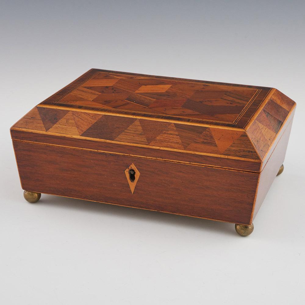 Heading : Regency Tunbridge ware work box with cubework
Date : c1825
Period : Regency
Origin : Tonbridge or Tunbridge Wells, Kent
Decoration : Perspective cubes to the etnre with van dyke type decoration to the side panels of the cover. Four ball