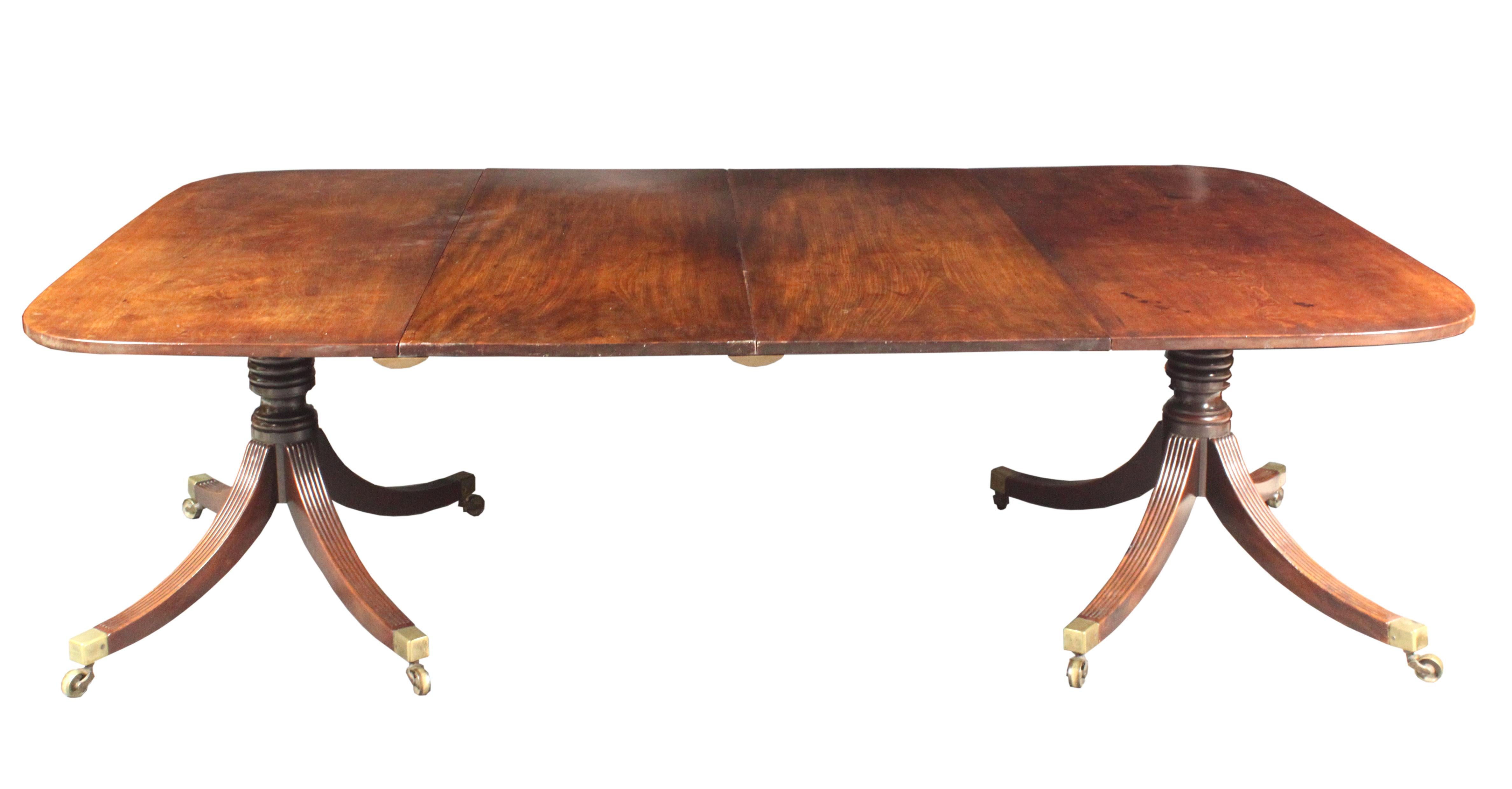 Georgian dining table in mahogany of a good rich color and patina on elegant twin pedestal four splay bases.
The two end tops and pillars are original; two centre leaves have been replaced in well matched Georgian timber and are supported by