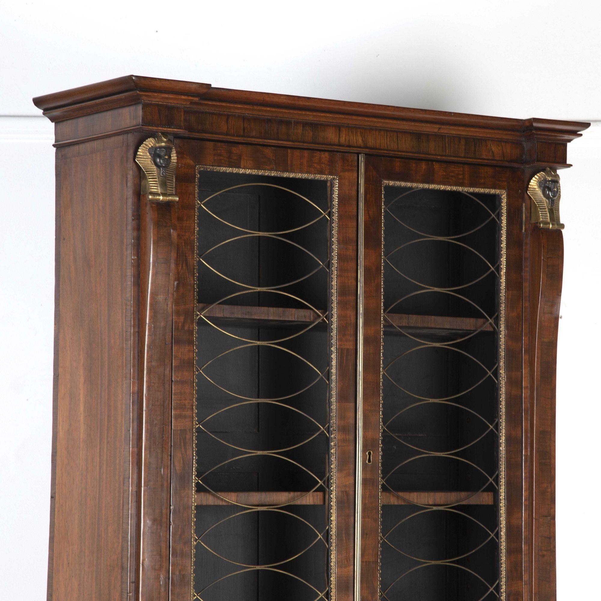 Wonderful 19th Century regency two-piece bookcase.
With Egyptian brass heads and feet to columns of the top and bottom pieces with a grill to the doors. With gilt brass to the inside of the frames.
A superb piece of storage furniture!